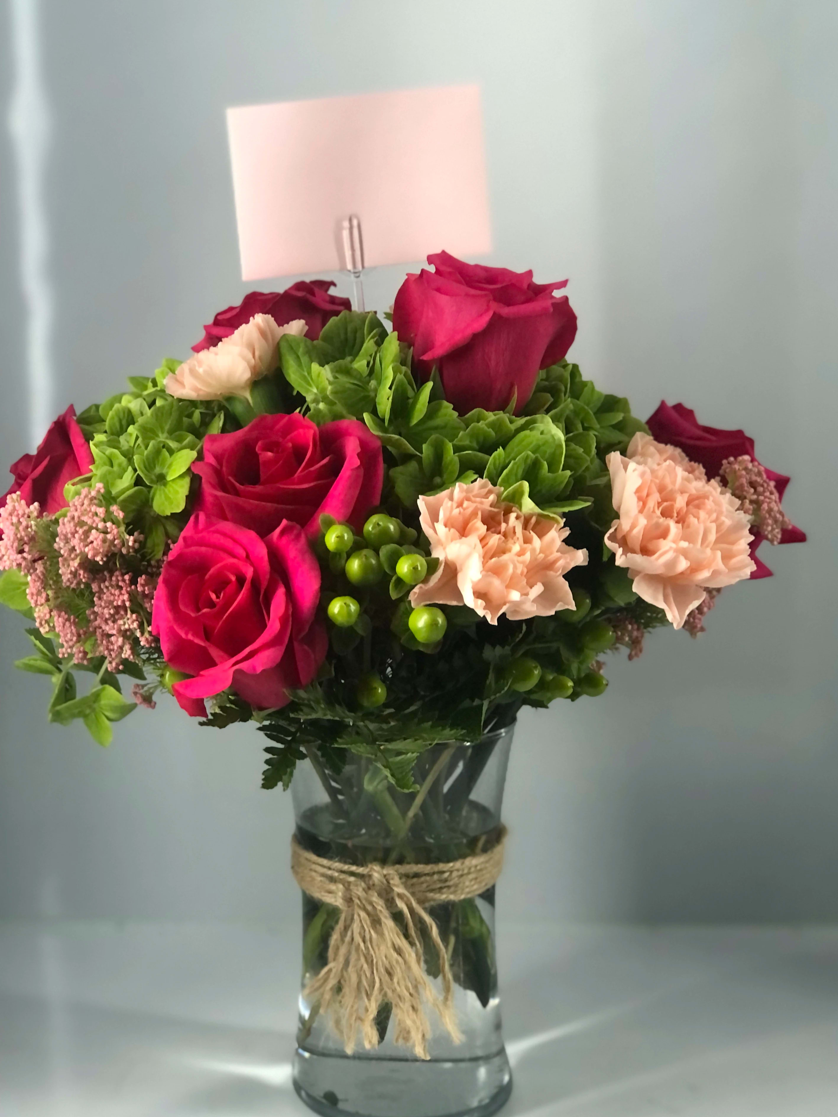 Hydrangeas,carnations and roses - Light foliage,  mostly beautiful blooms fill this glass vase 