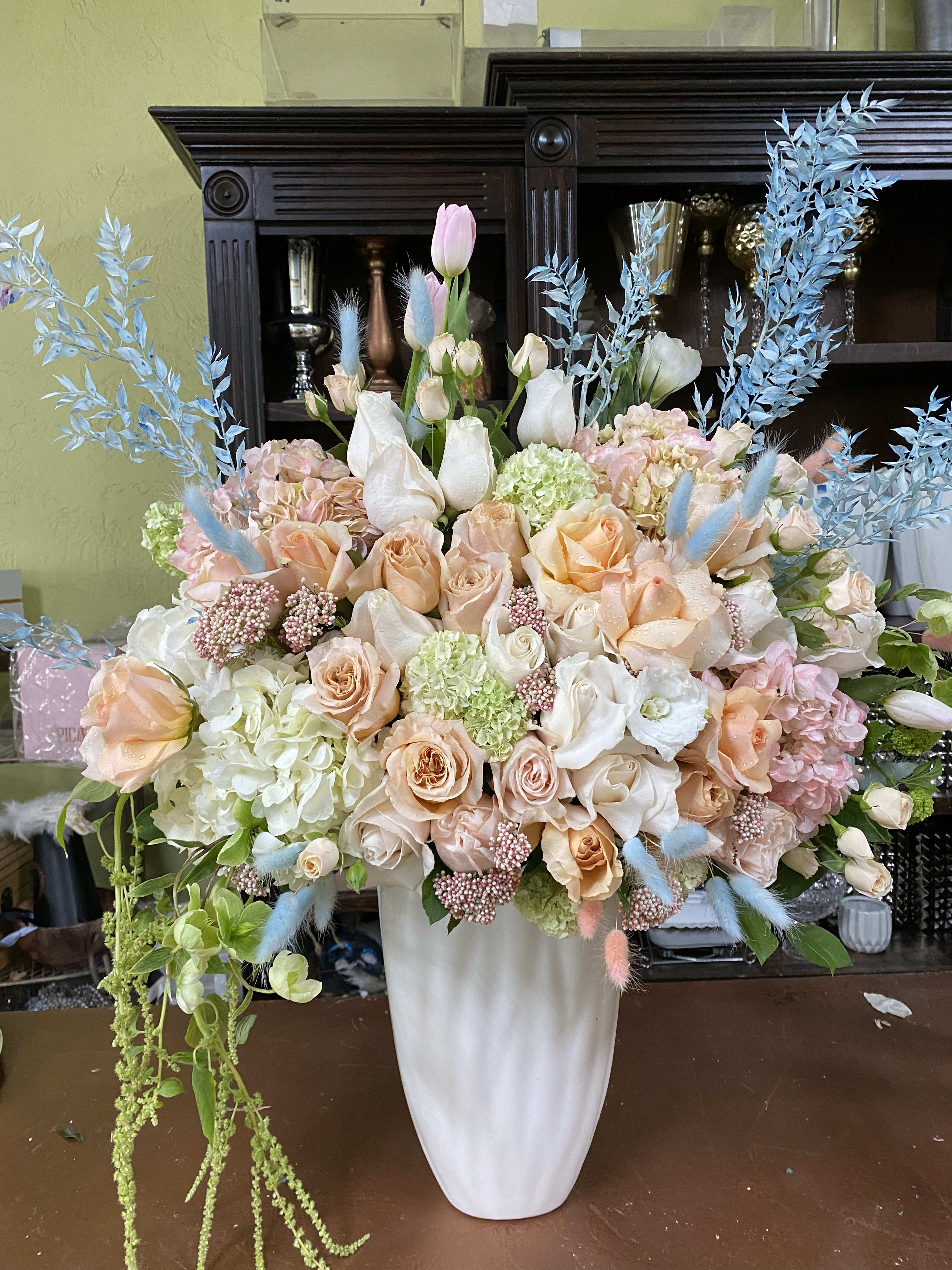 Peach Delight - Peach Shimmer roses tulips. Hydrangea mixed flowers in a tall white ceramic vase 