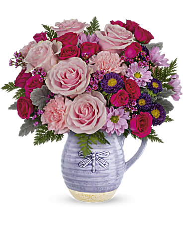 Playful Pitcher Bouquet - Gorgeous roses and a keepsake pitcher--it's the perfect 2-in-1 Mother's Day gift! Take her special day to new heights with this pink-tastic bouquet and glazed, food-safe ceramic pitcher with charming dragonfly motif. Pink roses, hot pink spray roses, purple matsumoto asters, pink carnations and lavender daisy spray chrysanthemums are arranged with lavender waxflower, dusty miller and leatherleaf fern. Delivered in Teleflora's Whimsical Dragonfly pitcher. Orientation: All-Around  SUBSTITUTION POLICY – Always deliver the freshest flowers! Please note the bouquet pictured reflects our original design.  If the exact flowers or container in this arrangement are not available, our local florists will create a beautiful bouquet with the freshest available flowers.
