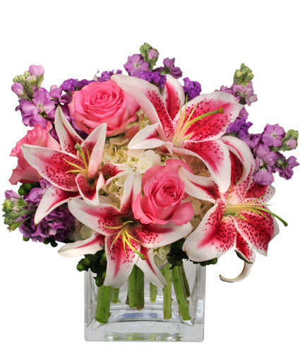 More Than Words...Flower Arrangement - Show that your love is beyond words with this stunning bouquet! The More Than Words arrangement is the perfect way to say, &quot;You deserve the world.&quot; With an exquisite mixture of pink and white lilies, lavender stock, pink roses, white hydrangeas, and purple statics, this dreamy bouquet will have them falling in love with you all over again. 
