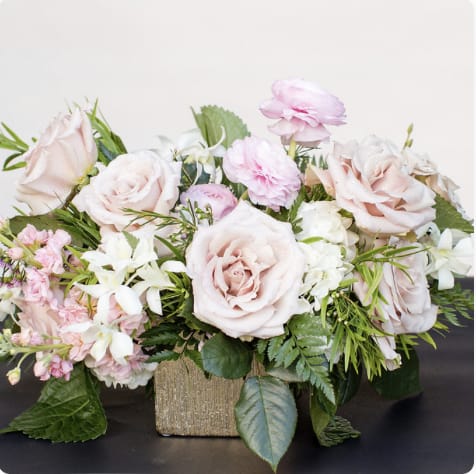 Garden romance - Soft, muted and whimsical, this arrangment romantically blends lighter colored seasonal garden blooms and dainty accents.  Designed in a gold or silver tone vessel.  Designed to be viewed from all angles.  Enhanced option includes additional blooms and foliage.  All floral arrangments are designed to a style and use seasonal materials of varying content.  Please contact us directly for any custom orders or requests info@helemelebotanicals.com or 808.226.7667.  We are committed to malama 'aina and strive to use locally sourced material, reduce packaging and reuse and recycle where possible. We will pick up any of our product (vessels, plants and floral supply material) when delivering a subsequent order. At that time, a $5 credit toward future purchase will be issued for each ceramic, metal or wood vessel returned.