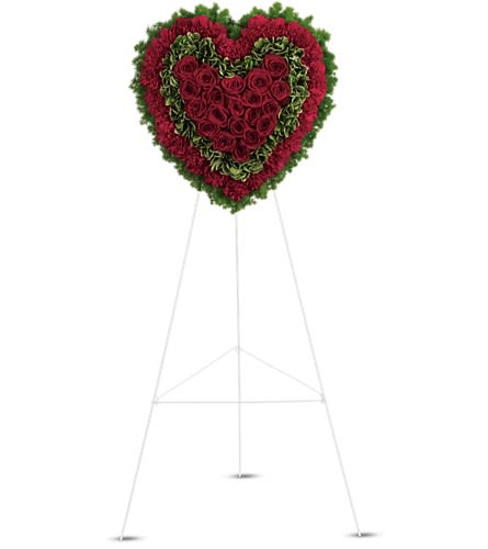 Radiant Heart - Remember a loved one's generous heart with this red arrangement in a classic heart shape a declaration of eternal love and devotion. Solid red roses matched with deep red carnations are surrounded by variegated greens and fern.Approximately 21&quot; W x 21&quot; H Orientation: One-Sided As Shown : T225-1A