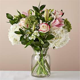 Role Model Bouquet - With soft colors and rich texture, this bouquet elegantly expresses your appreciation on Mother's Day. Composed of bursting lilies,  roses and voluminous hydrangeas, send this bouquet to your Mom, your grandma, or aunt on her special day