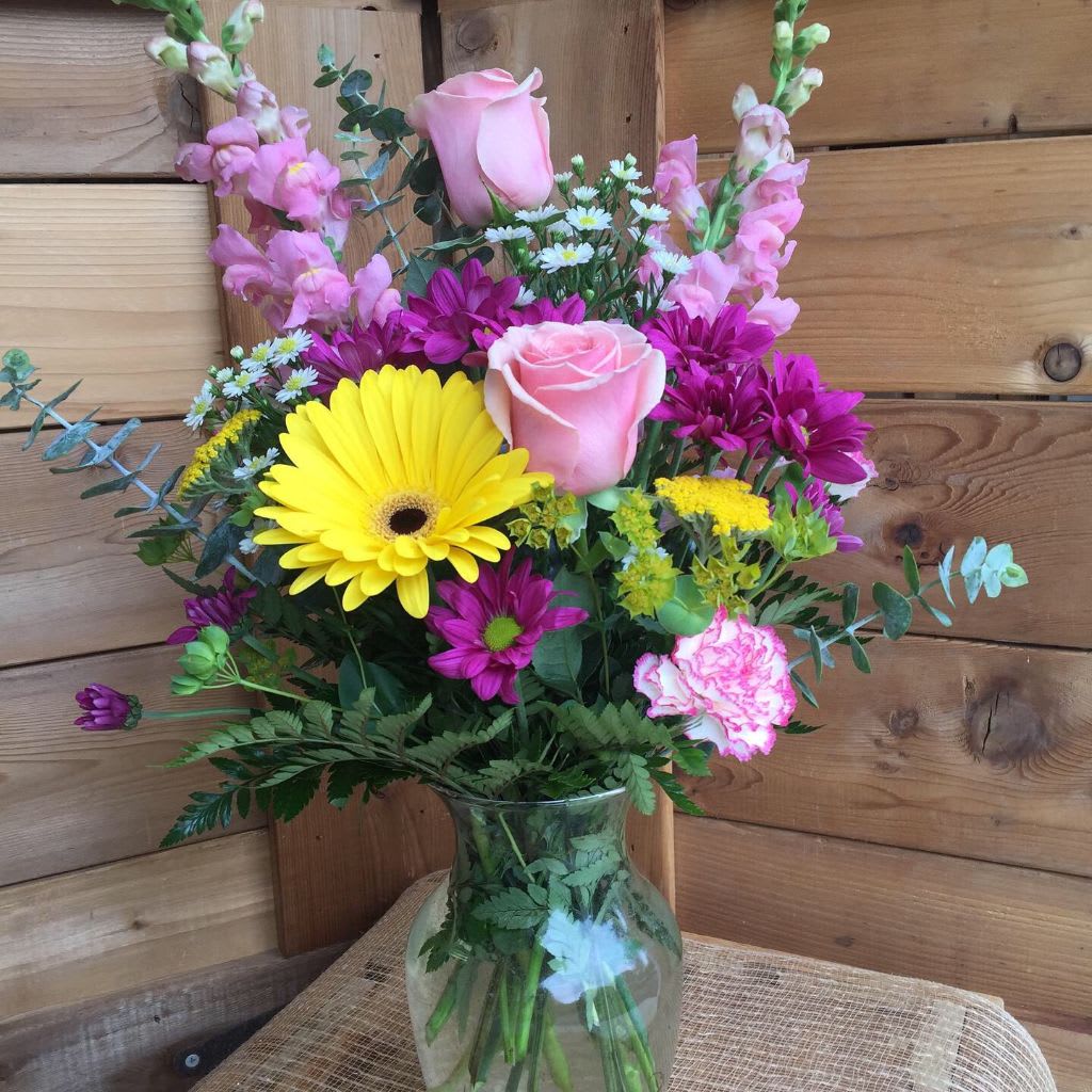 Bright Sunshine - Beautiful mix of pink snapdragons, pink roses, yellow gerbera daisies, along with a mix of eucalyptus and a variety of local filler flowers make this a bright colorful bouquet.  Great for a birthday or any occasion.