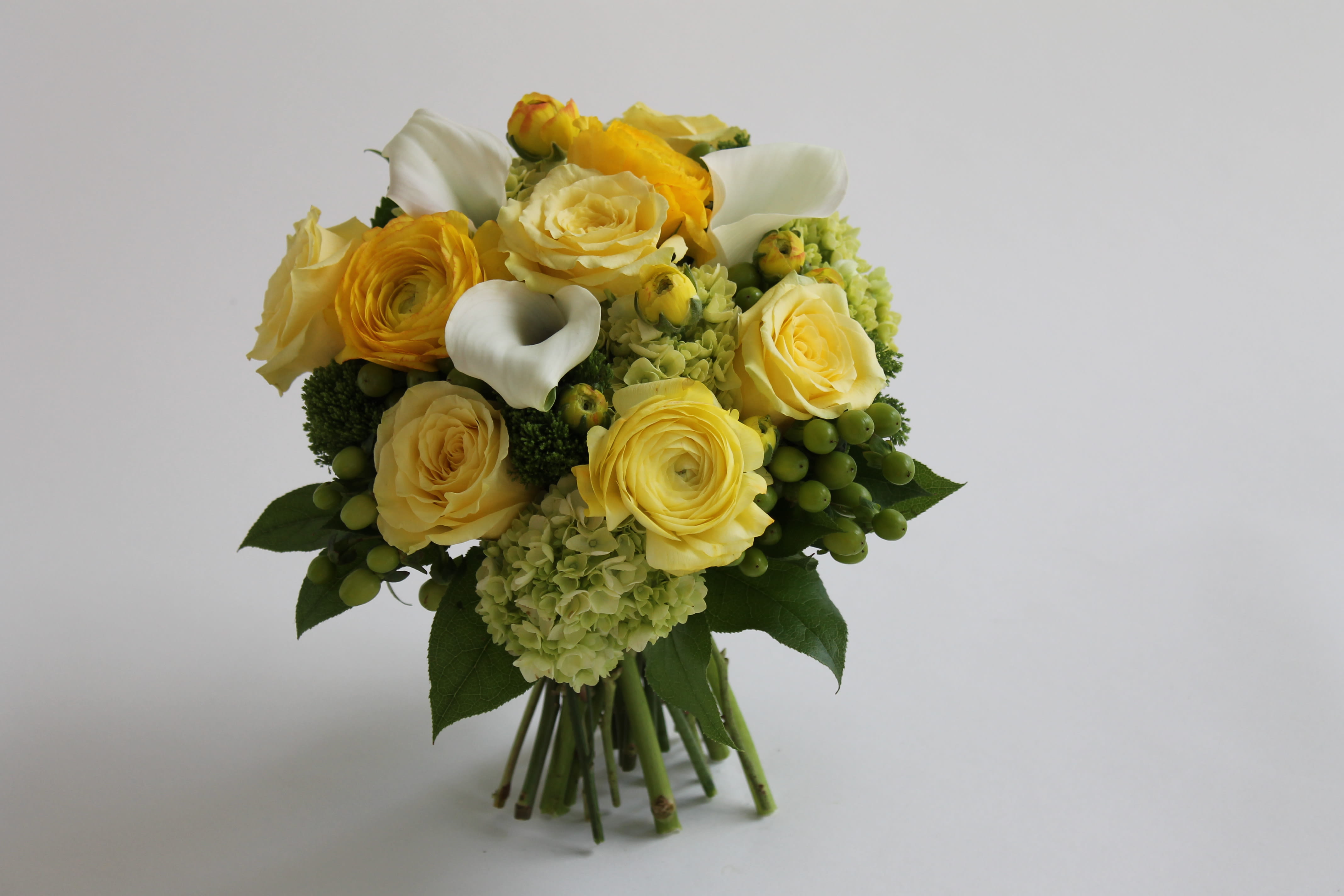 Lemon Zest - If you want to brighten someone's day this bouquet is sure to do the trick.  When this cheery combination of yellow roses, ranunculus, white mini callas and hydrangea is received smiles will abound! 