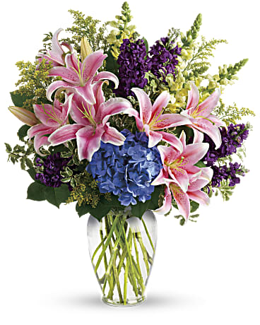 Love Everlasting Love Everlasting - The radiant bouquet includes blue hydrangea, pink oriental lilies, yellow snapdragons and purple stock, accented with assorted greenery.