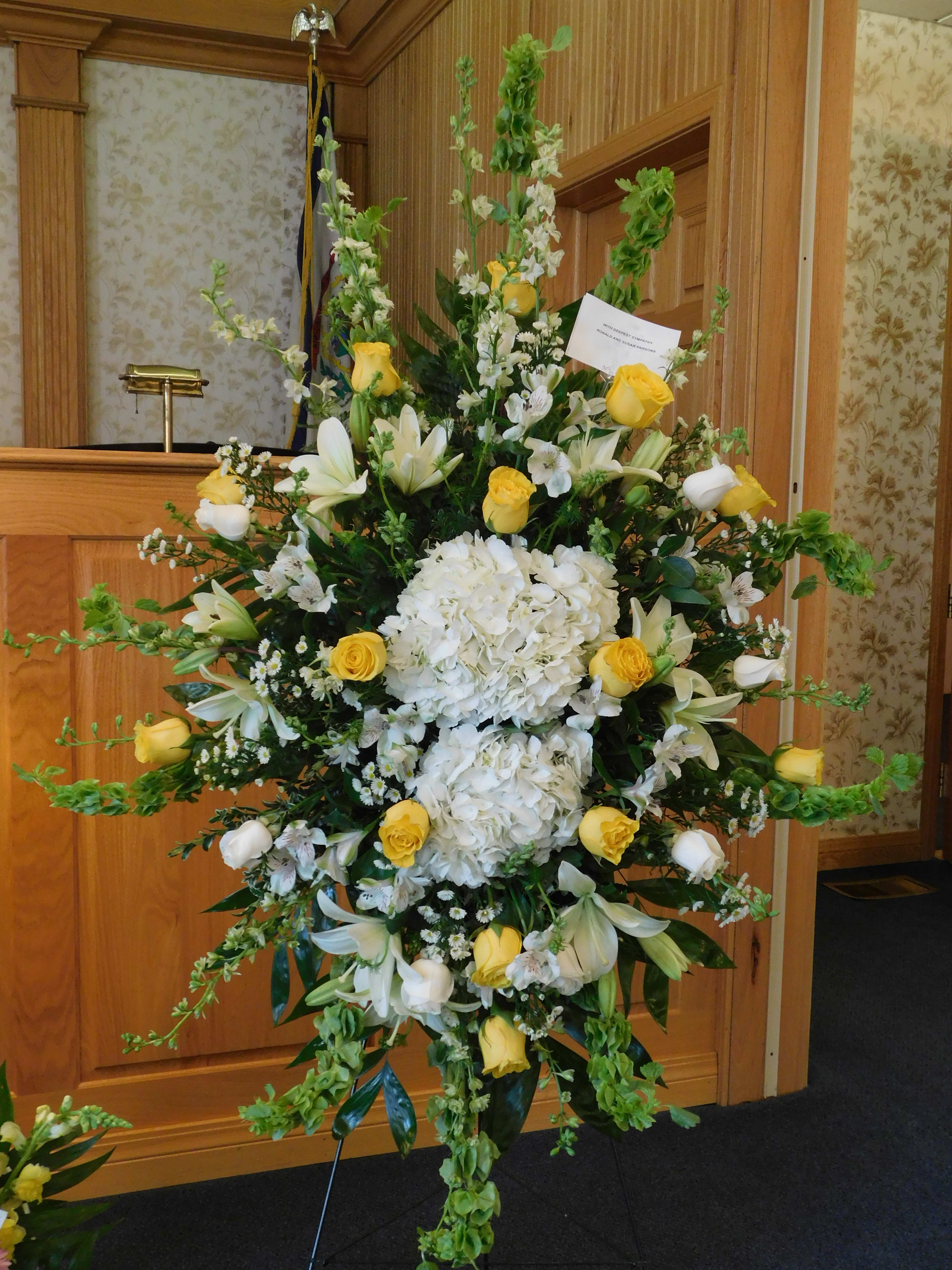 Fondness Farewell Fondness Farewell - White and yellow roses, hydrangea, belles of Ireland and greenery. This standing spray captures the eye with it's lush greens and elegance.