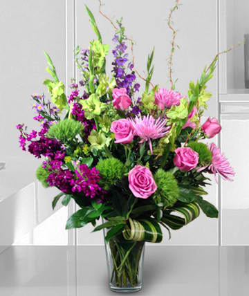Fresh Beauty Fresh Beauty - Beautifuly fresh arrangement of greens and purples will brighten anyone's day. Substitutions of equal or greater value may be made depending on season and availability of product or container.