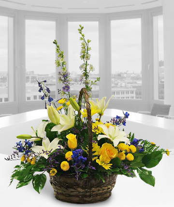 Enchantment Enchantment - Basket of complementary blues and yellows. Substitutions of equal or greater value may be made depending on season and availability of product or container.
