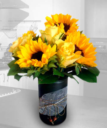 Sunflower bouquet in a black vase with a decorative ribbon wrap
