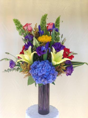 EBF-5023 - Bright and colorfull arrangement. lilies, roses, sunflowers iris hydrangeas, arranged in a 8&quot; cylinder vase.  