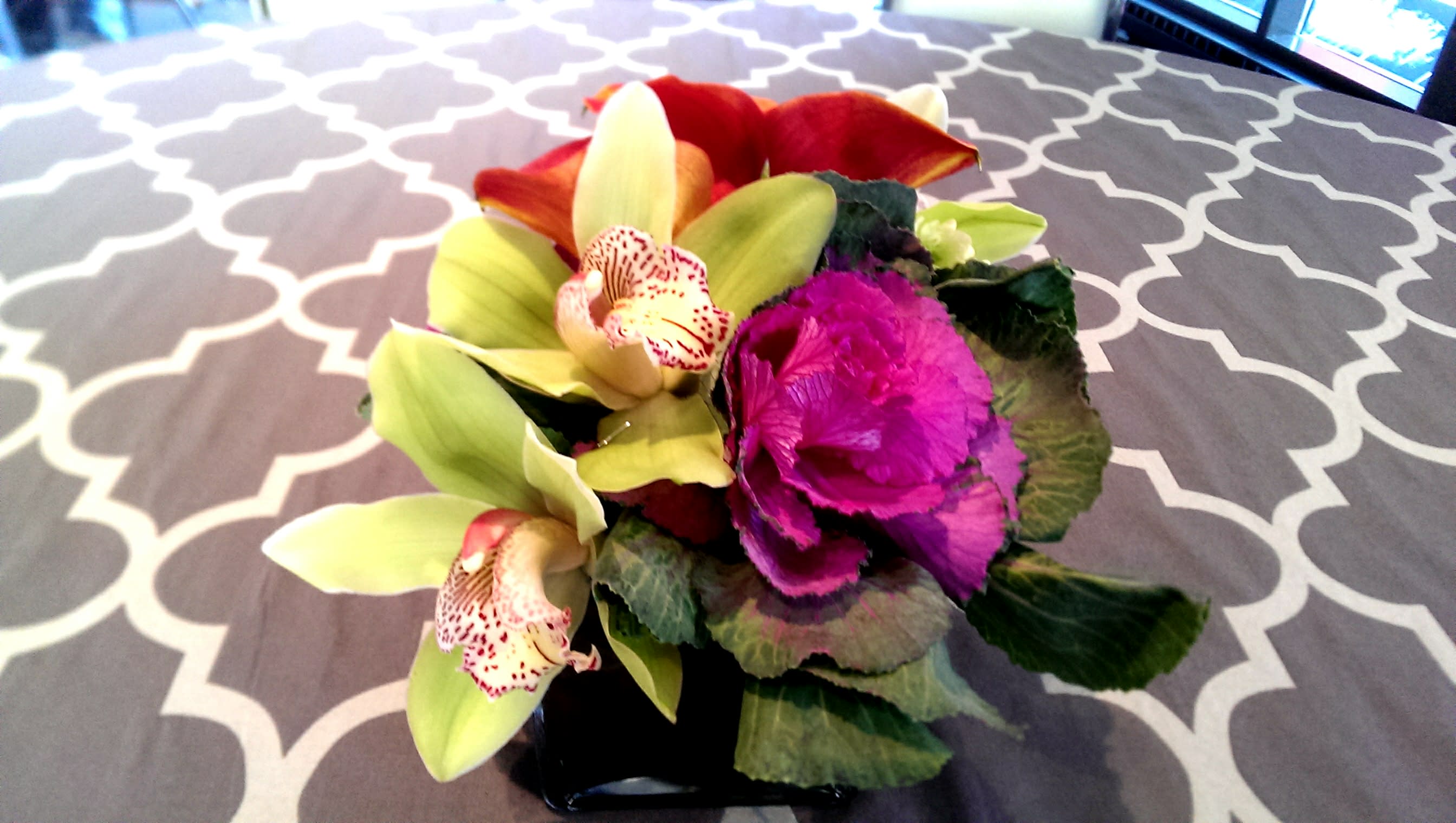 Mango Kale - Calla lilies, kale, &amp; cymbidium orchids In a square glass container.