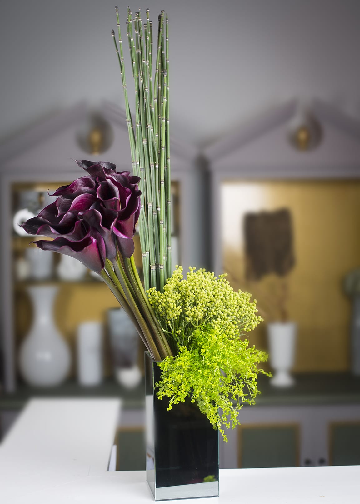 Smoked Mirror - Calla lilies, snake grass, &amp; fern in a smoked mirrored container.