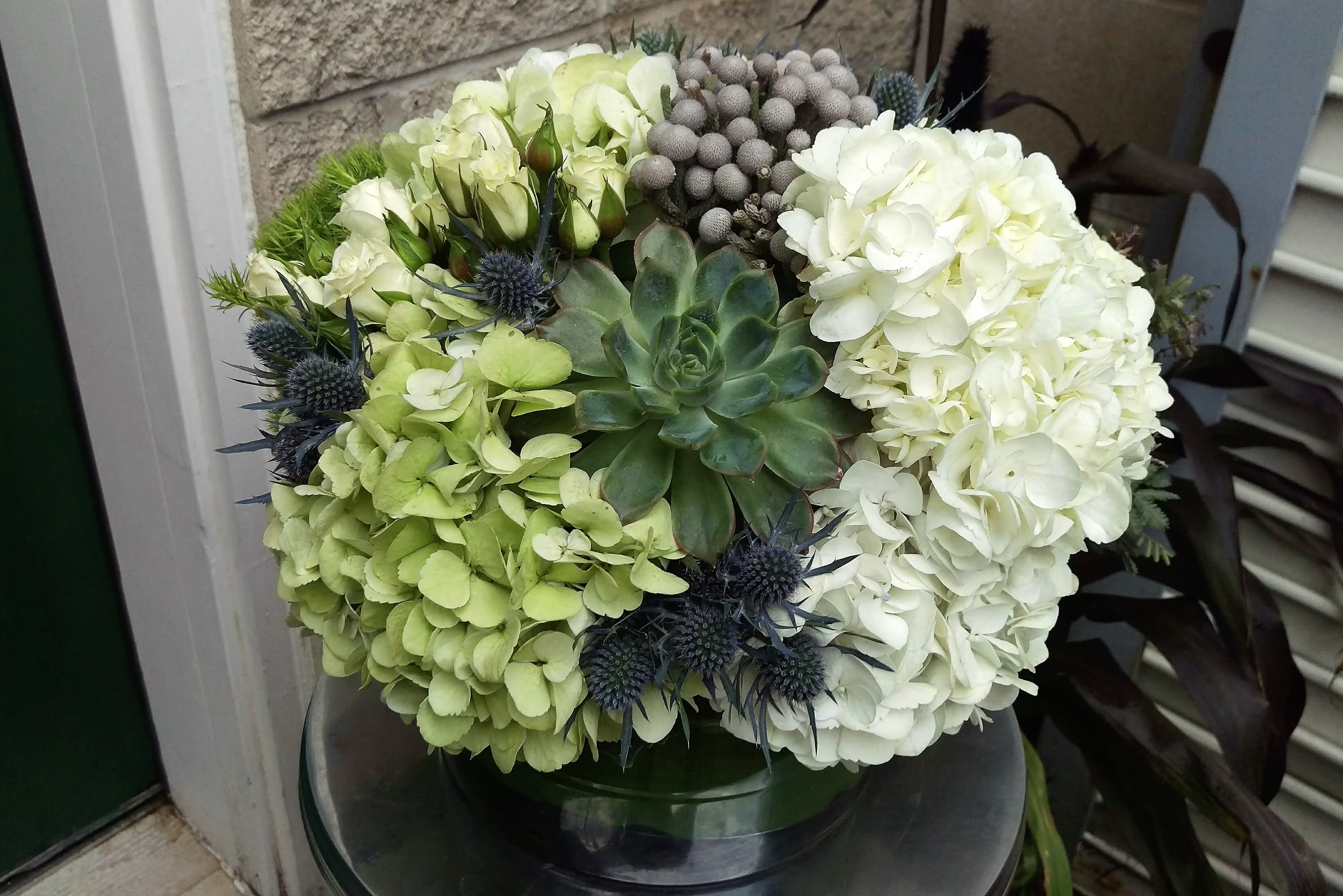 Mason - Hydrangea, spray roses, thistle, trick &amp; succulent in a ti leaf wrapped glass container