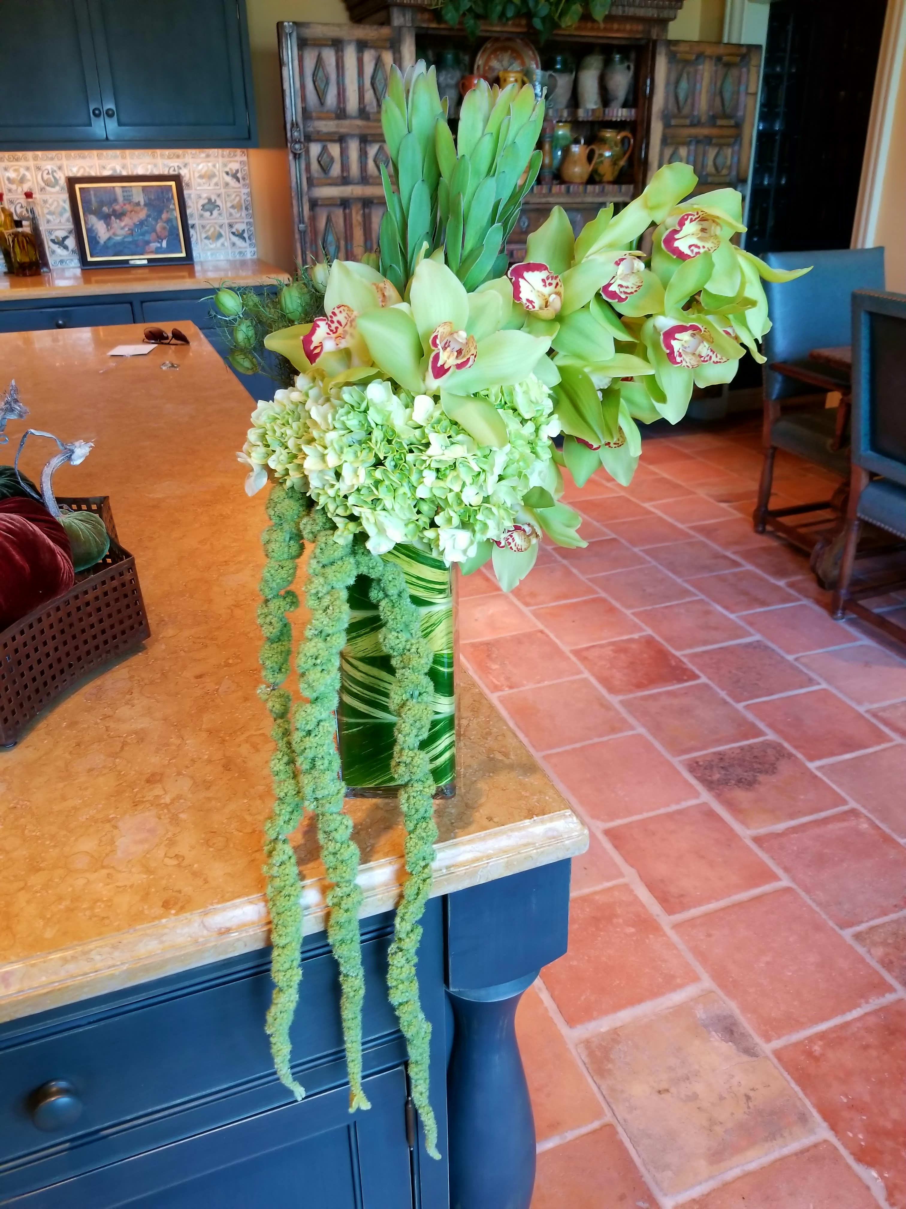 L K Green - Hydrangea, cymbidium orchids &amp; hanging amaranthus in a tall square leaf wrapped container. 