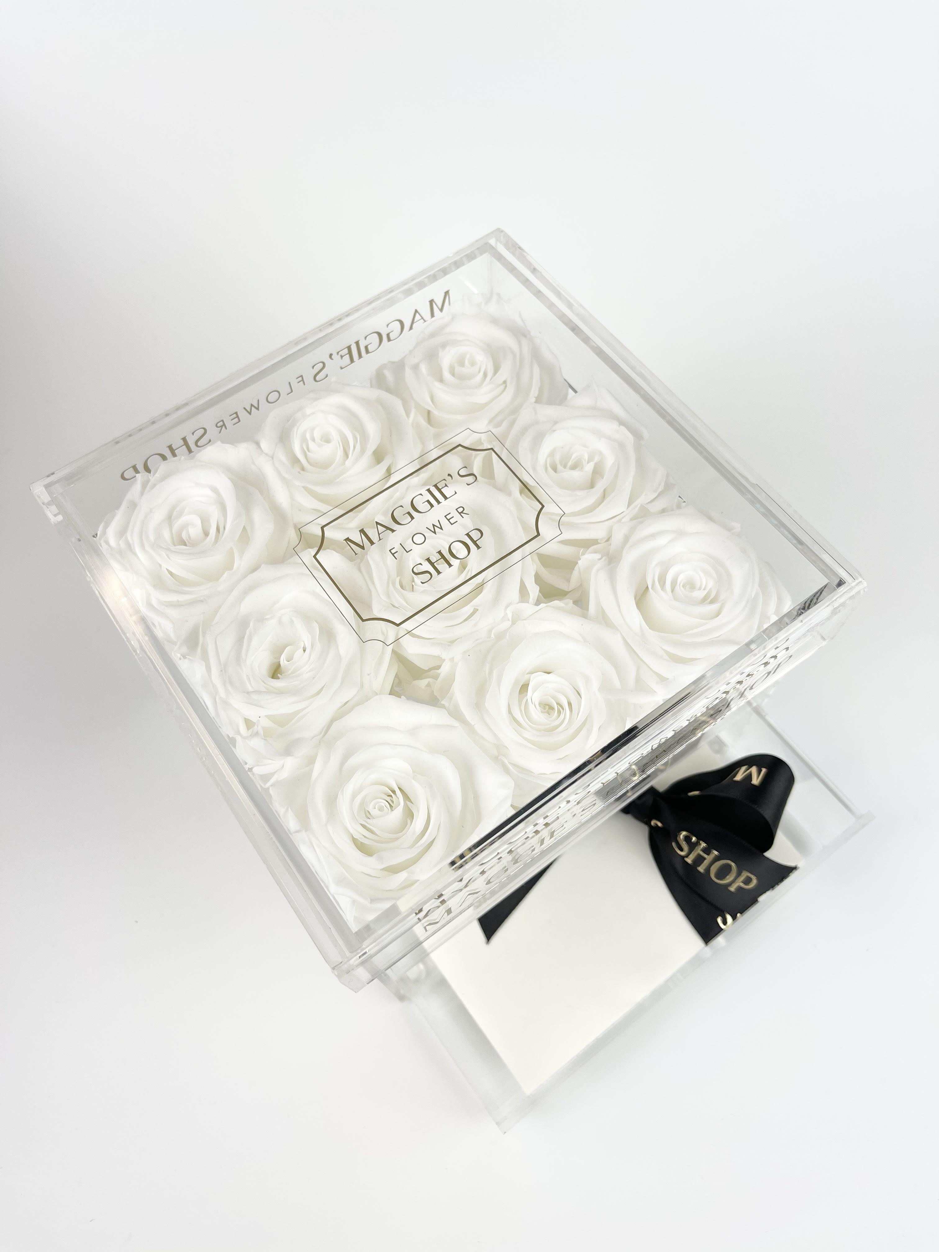 9 White Eternity Roses (Acrylic Collection) - Eternity roses are real roses that have been preserved to last up to 3 years!    Arrangement includes : 9 Scented Eternity Roses  MFS custom acrylic box with drawer perfect to store small items like jewelry, makeup, etc.  