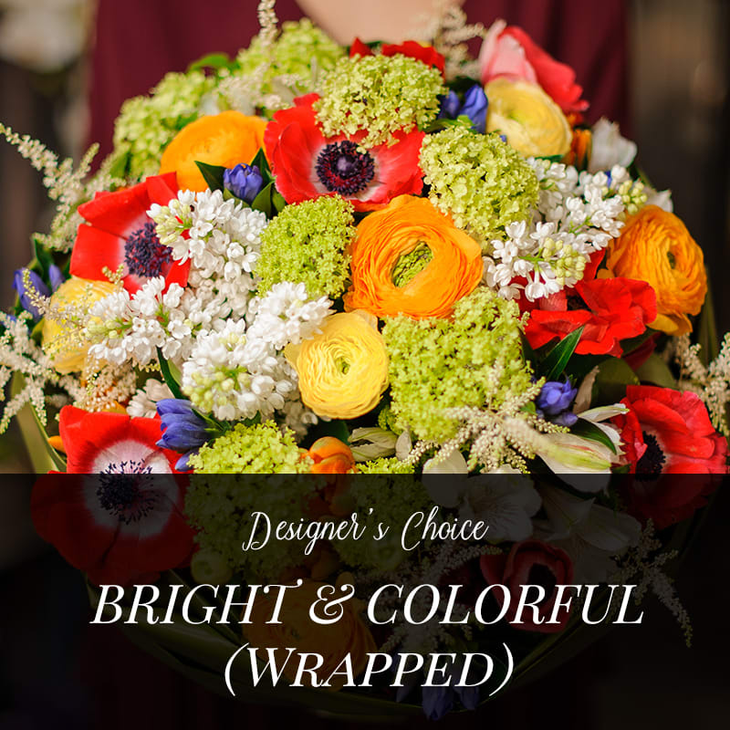 Designer's Choice Bright &amp; Colorful (Wrapped)  -  No vase included. Our designers will prepare a lovely combination of fresh cut flowers for your recipient to enjoy designing in their own vase. The flowers used will be a lovely combination of flowers in a bright colorful palette, from our freshest selections. No labor or vase included, the full dollar value of your flower order will be used for flowers.