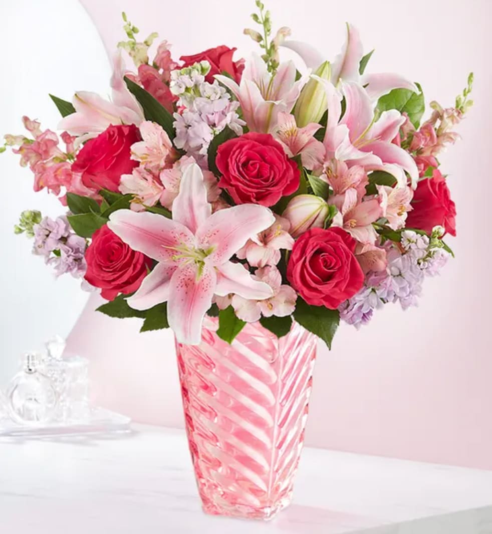 Mother's Embrace™ - Thank Mom for a lifetime of hugs with our beautiful bouquet. A mix of blooms in shades of pink is designed in our keepsake vase with a spiral design.