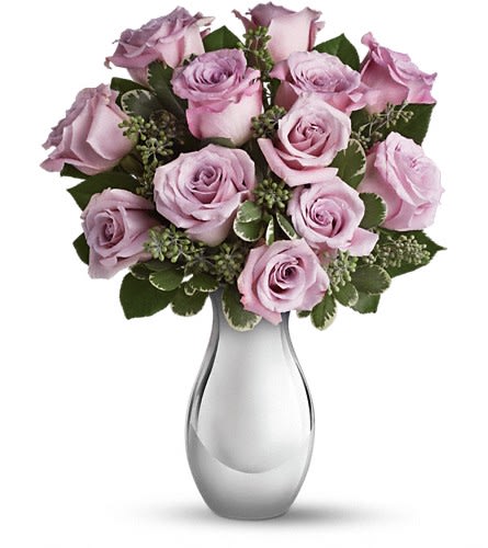 Teleflora's Roses and Moonlight Bouquet - Presenting one dozen luscious lavender roses artistically arranged in a glorious Silver Reflections vase - the effect is nothing short of breathtaking. This flower arrangement can be delivered the same day!!! Imagine her excitement when this magnificent bouquet arrives at the door. The beautiful bouquet includes twelve lavender roses accented with assorted greenery. Delivered in Teleflora's exclusive Silver Reflections vase. Approximately 12 1/2&quot; W x 16&quot; H Orientation: All-Around As Shown : T403-1ADeluxe : T403-1B
