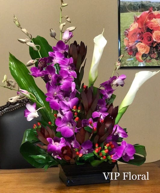 Garden Of Dreams - Purple dendrobium orchids, white calla lilies, leucadendron, hypericum, tropical leaves.