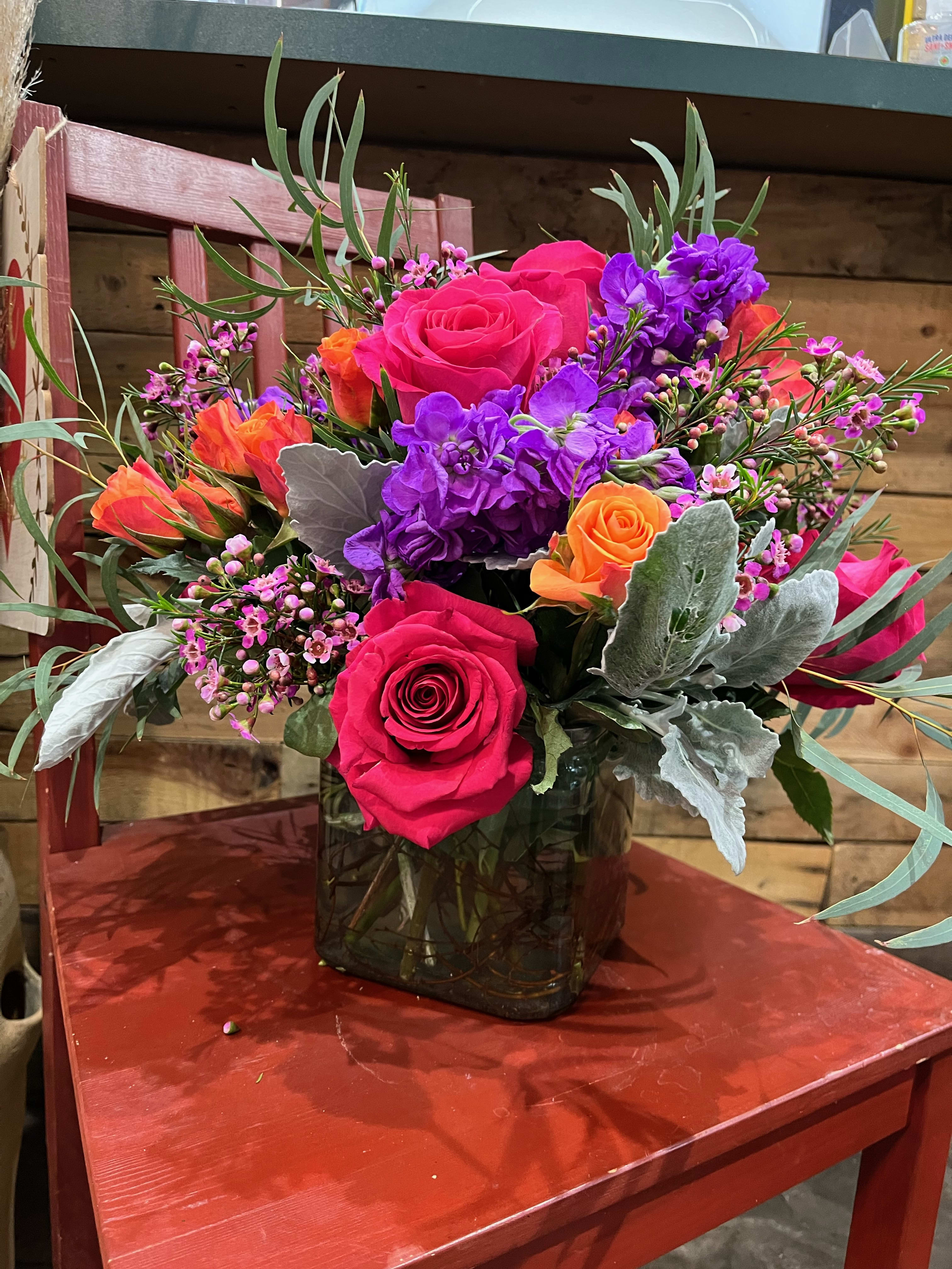 Color Burst - A vibrant arrangement of colorful blooms, such as roses, spray roses, and wax flower. *SUBSTITUTIONS MAY BE APPLIED*