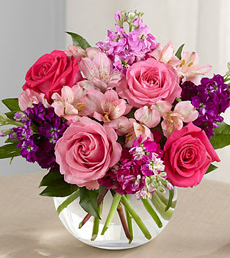 Tranquil Bouquet - The Tranquil Bouquet blooms with a sweet sophistication and style to bring a calming grace to any event or occasion. Hot pink and pink roses are brought together with purple, lavender and fuchsia stock stems accented with pink Peruvian lilies and lush greens to create a simply stunning flower arrangement. Presented in a clear glass bubble bowl vase, this exquisite fresh flower bouquet will make an excellent birthday, anniversary or sympathy gift. 