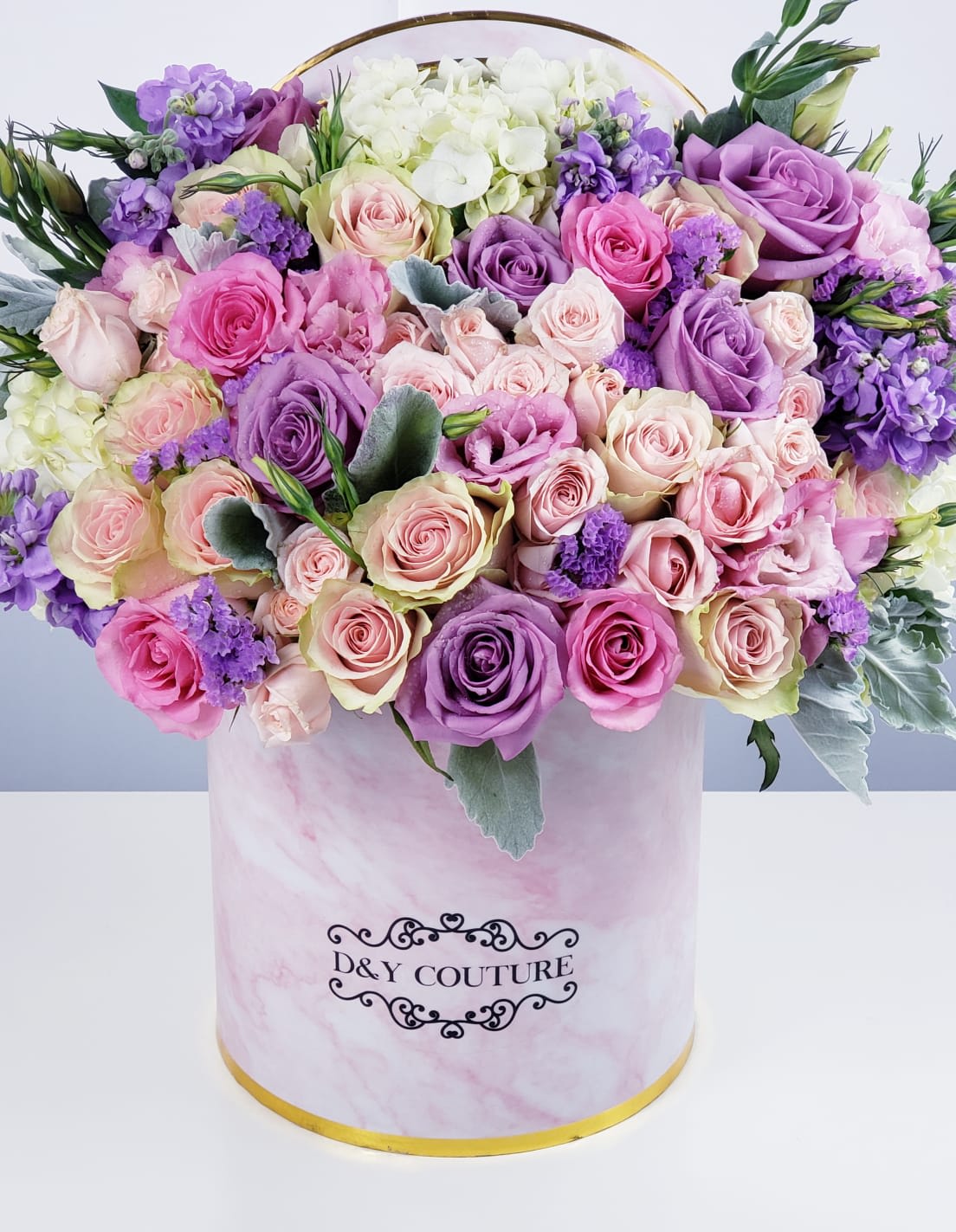 Nicole - Having a hard time finding the words to express your feelings? Let this Mixed Flower arrangement in D&amp;Y Couture Signature Box do the talking!   Substitution Policy: In some instances, the florist photo may represent an overall theme or look and include a one-of-a-kind vase which cannot be exactly replicated. Although the actual bouquet may not precisely match the photo, its temperament will. Occasionally, substitutions of flowers or containers happen due to weather, seasonality and market conditions which may affect availability. If this is the case with the gift you've selected, the local florist will ensure that the style, theme and color scheme of your arrangement is preserved and will only substitute items of equal or higher value.