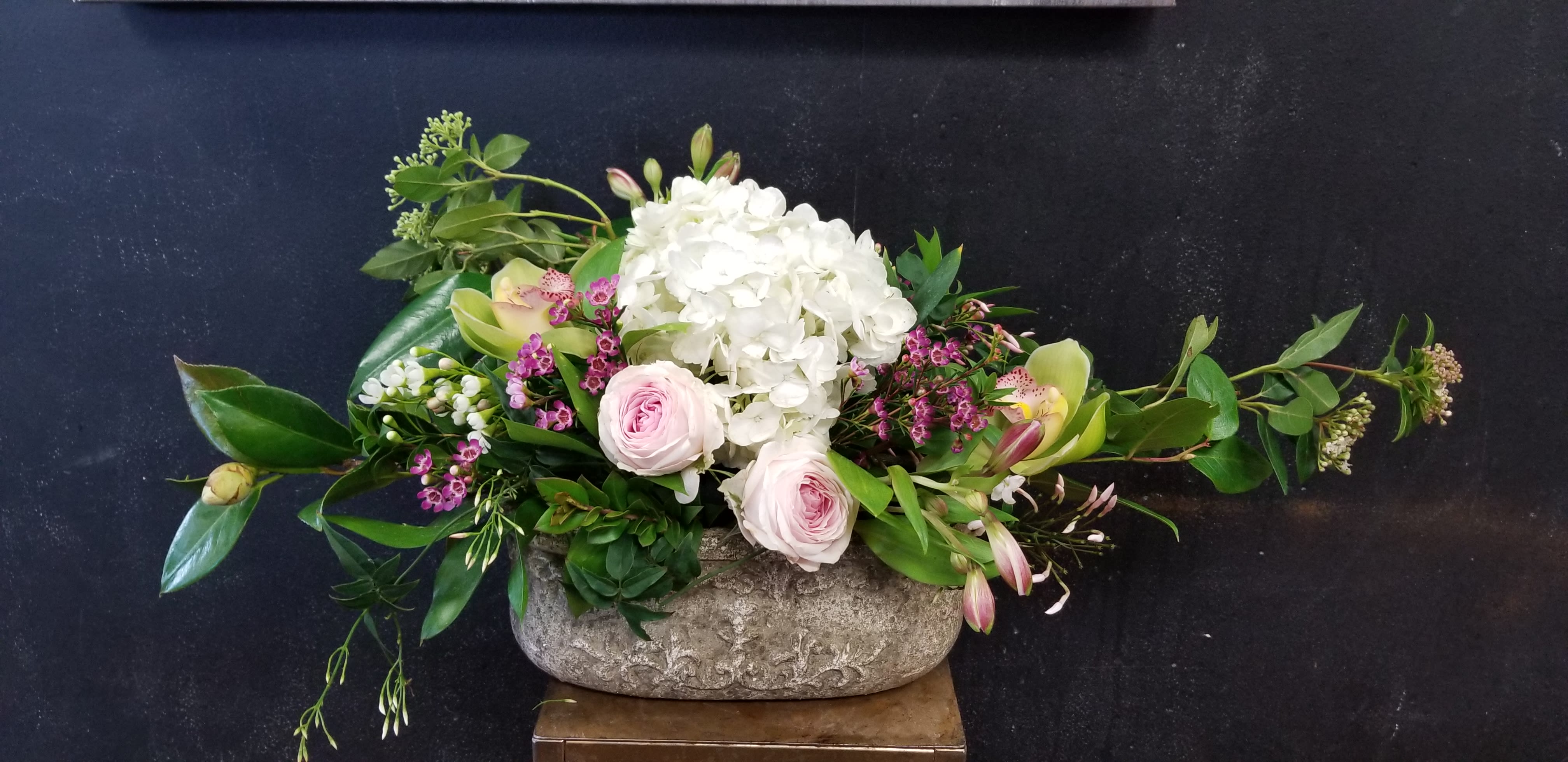 Spring Greetings - Mixture of a beautiful soft,pastel colors of flowers and foliages, filled in with special filler flowers arrangement Container may be different by availabilities.