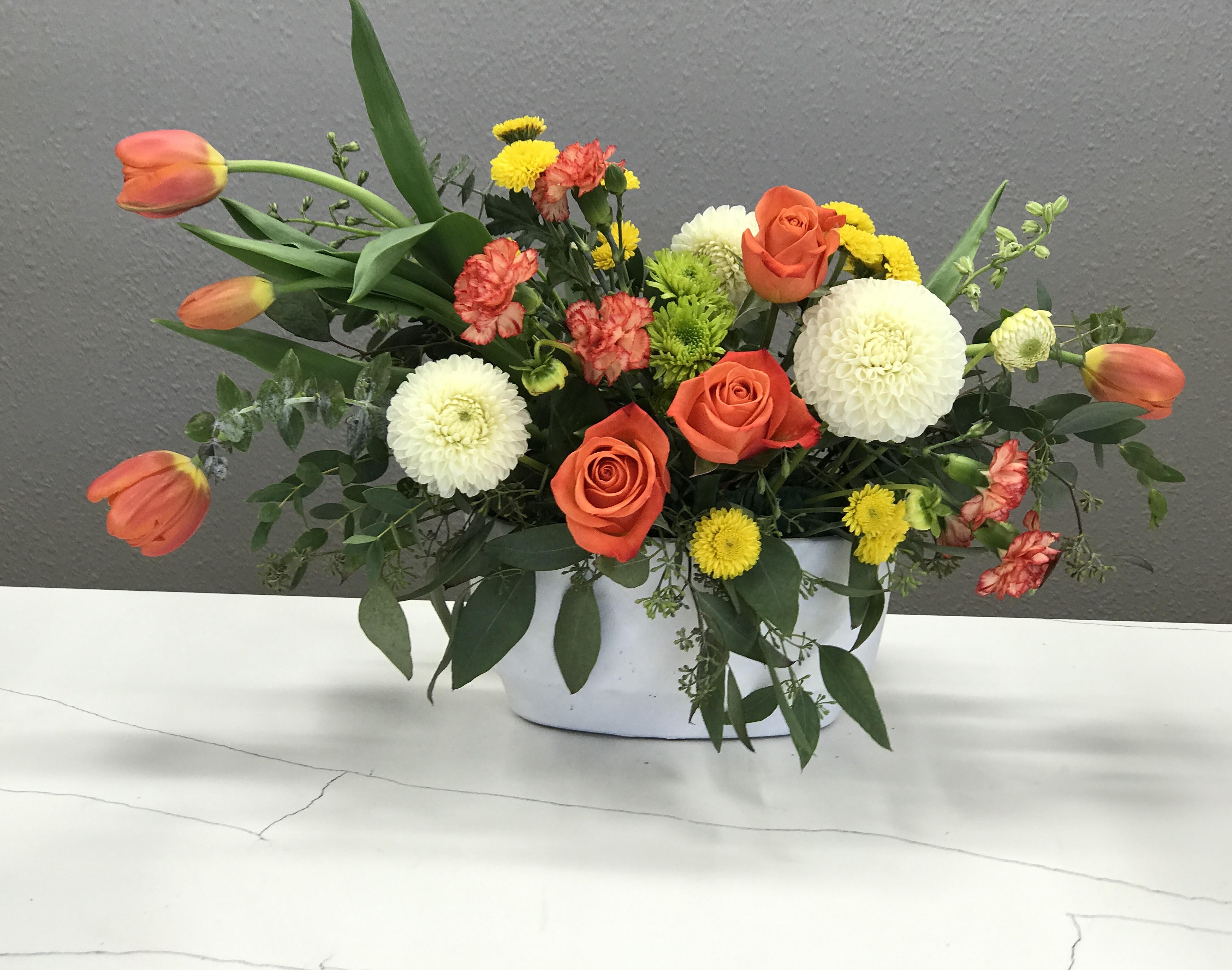 Tangerine Dreams  - Tangerine roses and tulips celebrated by bursts of white dahlias and green and yellow buds. 