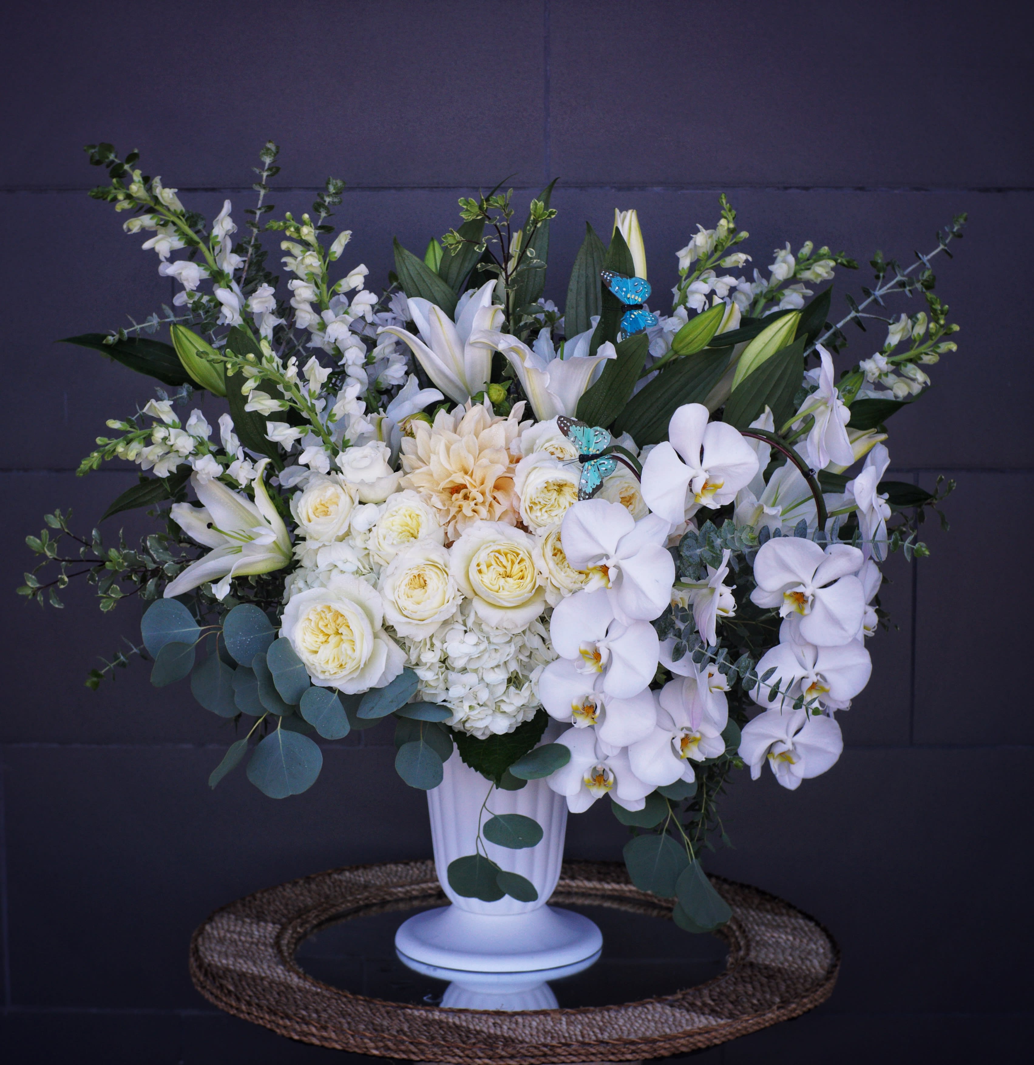 Unconditional Love - Elegant white including all premium fresh flowers: rose, orchid, lily... and nice accents in a tall vase.
