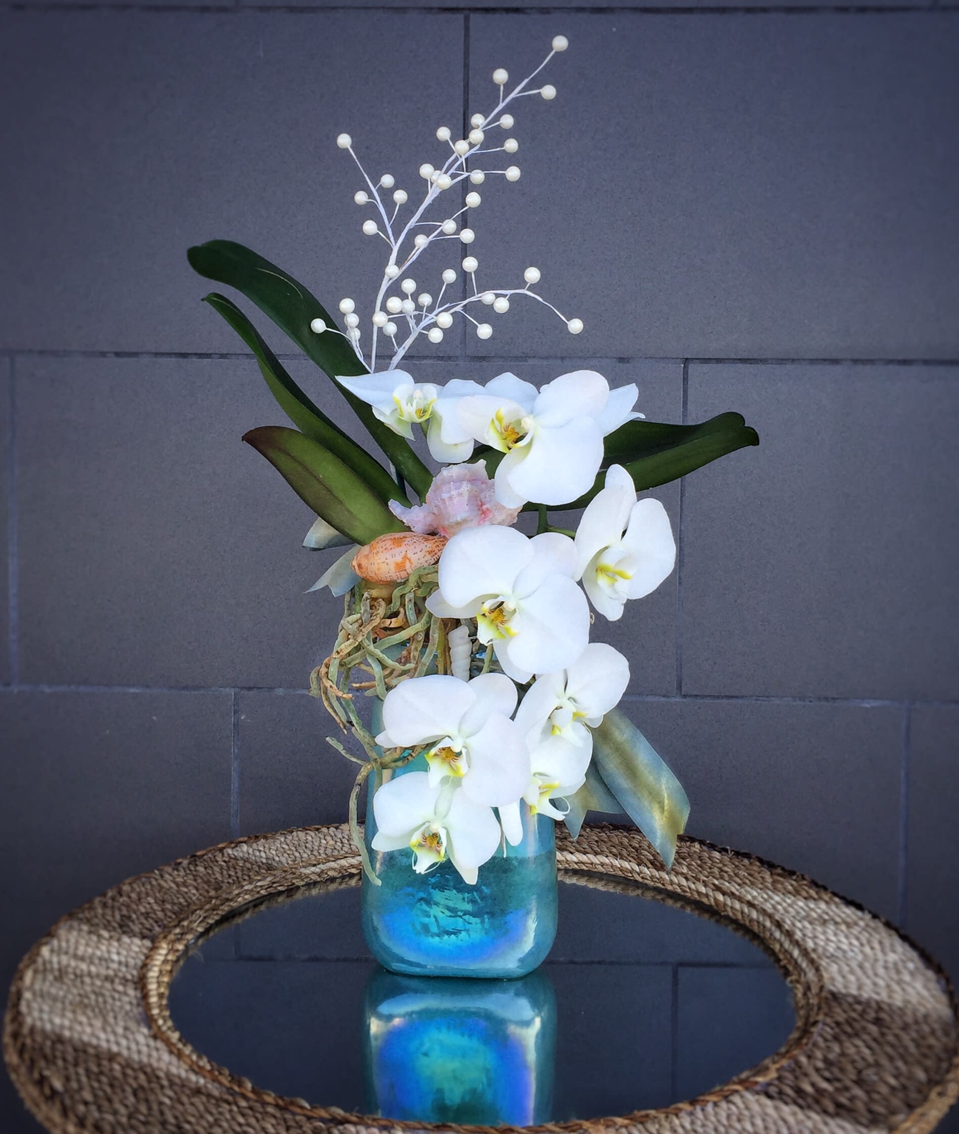 Jumping Dolphin - Oceanic design including orchids, pearls and sea shells in a nice aqua vase STANDARD: FIRST PHOTO DELUXE: SECOND PHOTO