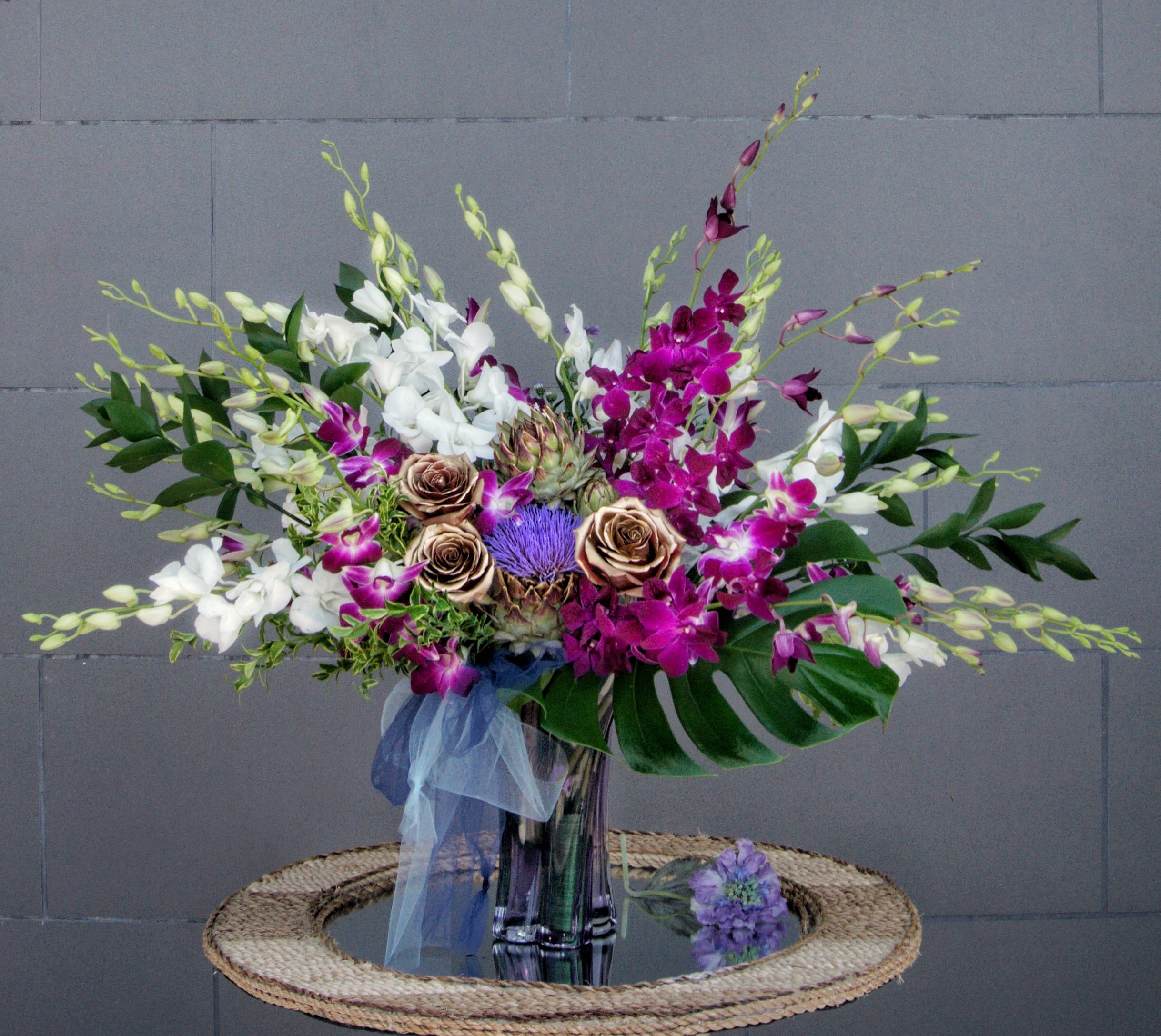 Love in Hawaii - Dendrobium orchids, pin cushion, roses with tropical accents in a nice vase