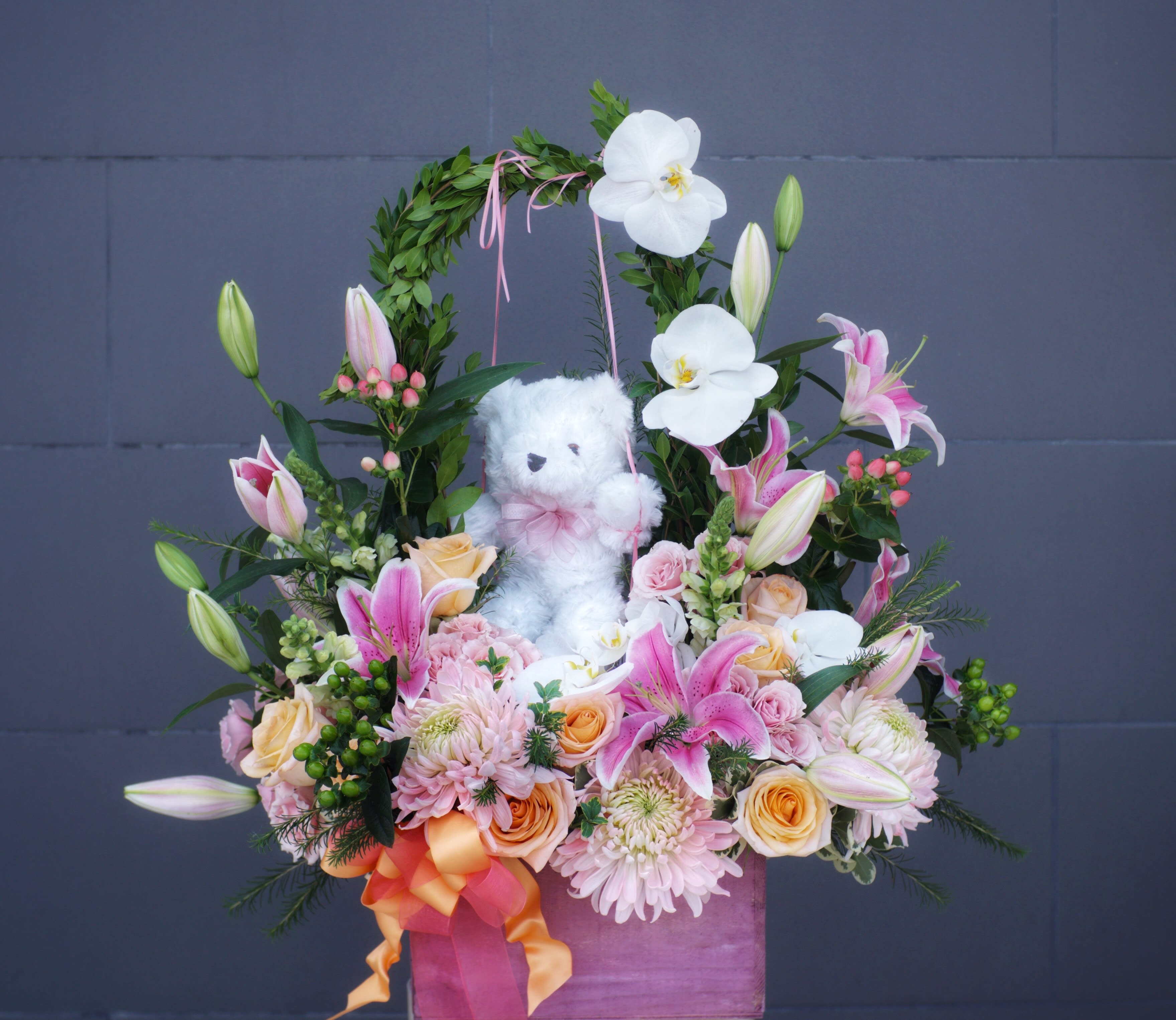 Beary Wonderland - Beautiful design including all premium fresh flowers in pink and white: rose, orchid, lily... with a cute Teddy bear.