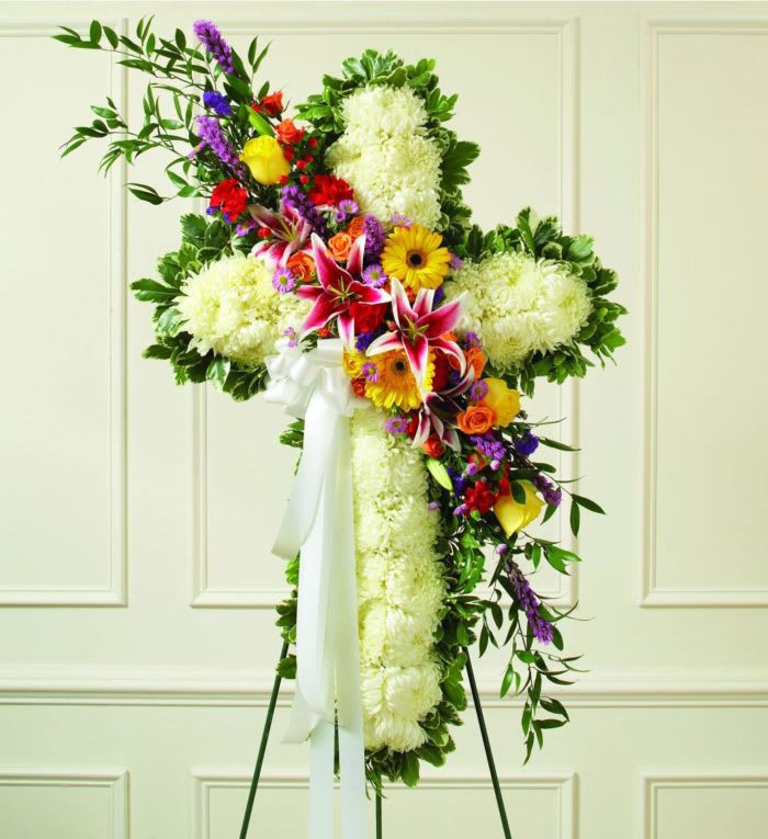 Colorful Sympathy Cross - A beautiful tribute to a life of happiness and friendship.  This Cross includes a variety of colorful blooms across a background of white.  This piece perfectly celebrates a life to be remembered.