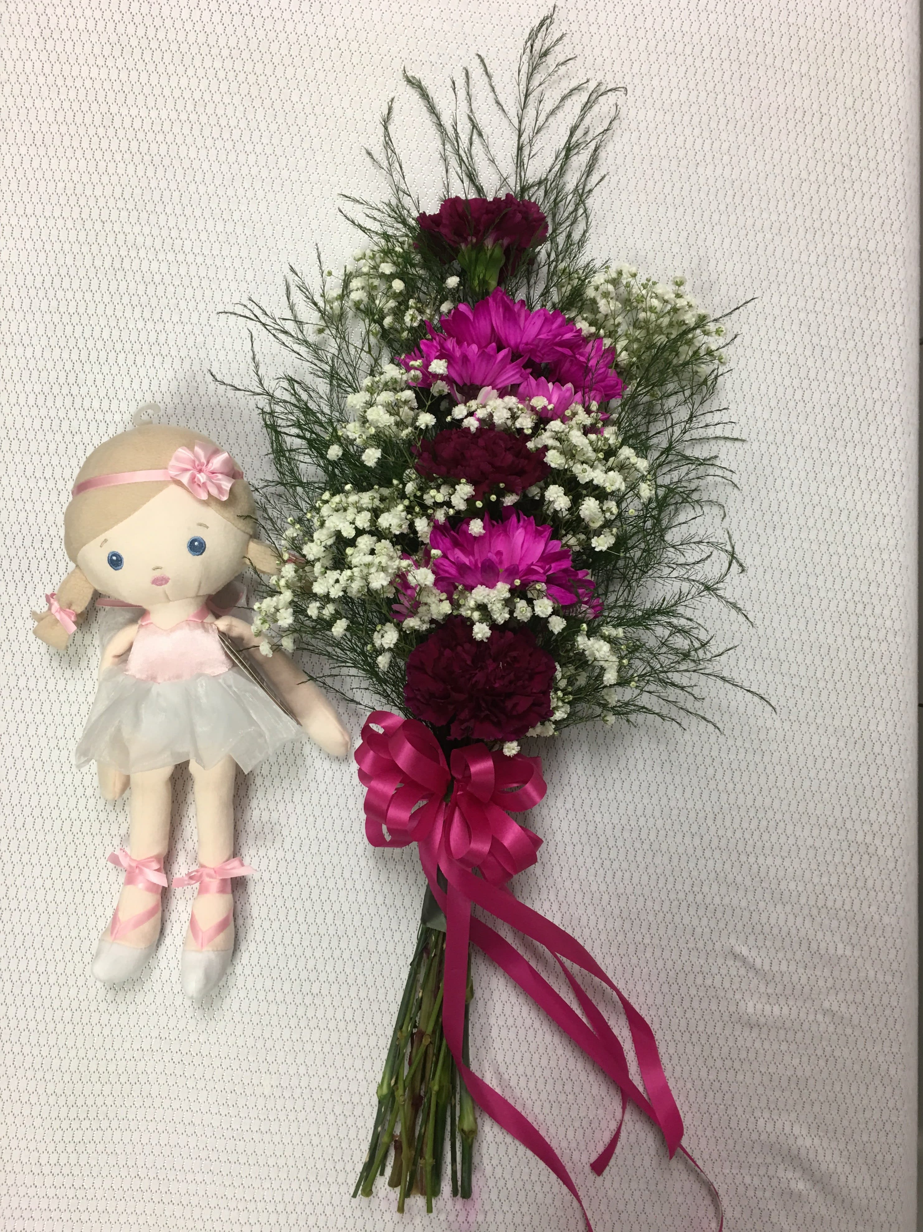Madame Butterfly FG901 - Lovely presentation for the &quot;little&quot; prima ballerina.  This floral display includes three carnations and two stems of daisies with a pretty bow.  THE DOLL IS NOT INCLUDED (She is shown to show the size of each presentation.)  Call the shop so we may coordinate the color with the costume or perhaps her favorite colors. Approximately 21&quot; long.    THIS IS A PICK UP ONLY ORDER. 