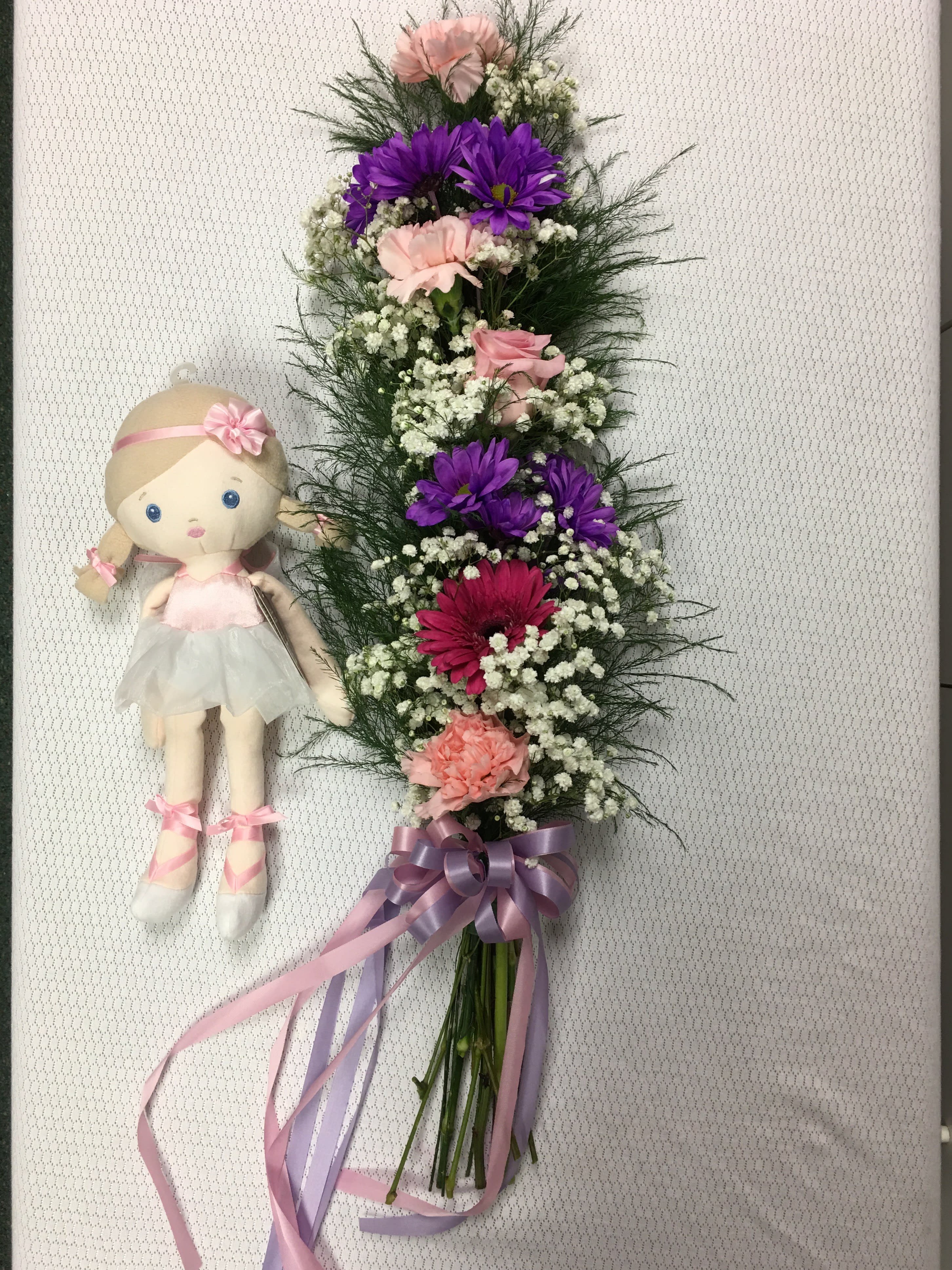 Dancing with the Stars FG903 - Celebrate the beautiful dancer in your life.  This floral display includes one gerbera daisy, one rose, three carnations and two stems of daisies.  THE DOLL IS NOT INCLUDED (She is shown to show size of each presentation)  This arrangement can be customized to your color choice.  Approximately 28&quot; long.    THIS IS A PICK UP ORDER.