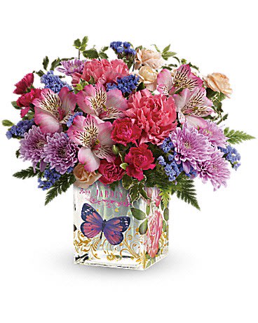 Enchanted Garden Bouquet Enchanted Garden Bouquet - A garden of love for Mom! Make her Mother's Day bloom brighter than ever with this sweet blend of pink and purple blooms. Hand-delivered in a keepsake cube vase with a vintage-inspired botanical print, it's a gift that will keep on giving, year after year. This colorful bouquet includes pink alstroemeria, pink carnations, miniature hot pink carnations, miniature peach carnations, lavender cushion spray chrysanthemums, purple sinuata statice, pitta negra and leatherleaf fern. Delivered in an Enchanted Garden cube vase. This is a one sided arrangement.