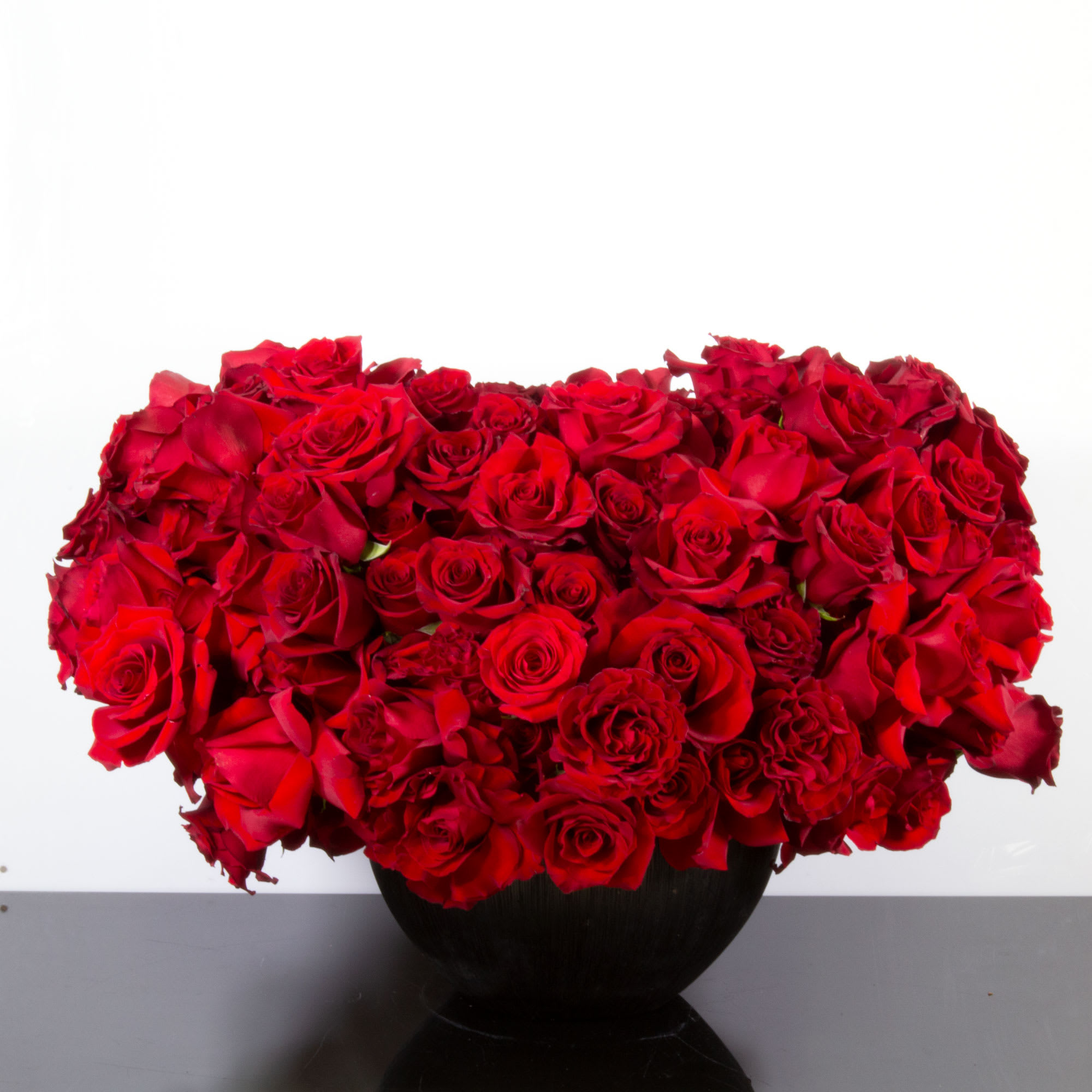 Where the Heart Is - An expression of love like no other. This fabulous and abundant heart shaped arrangement floats above its ceramic base. Gorgeous red Roses fill every inch to express your heart full of love. It will surely take their breath away, and touch their heart beyond belief!   Standard : 300 Roses as pictured  Deluxe: 500 Roses  Premium: 750 roses