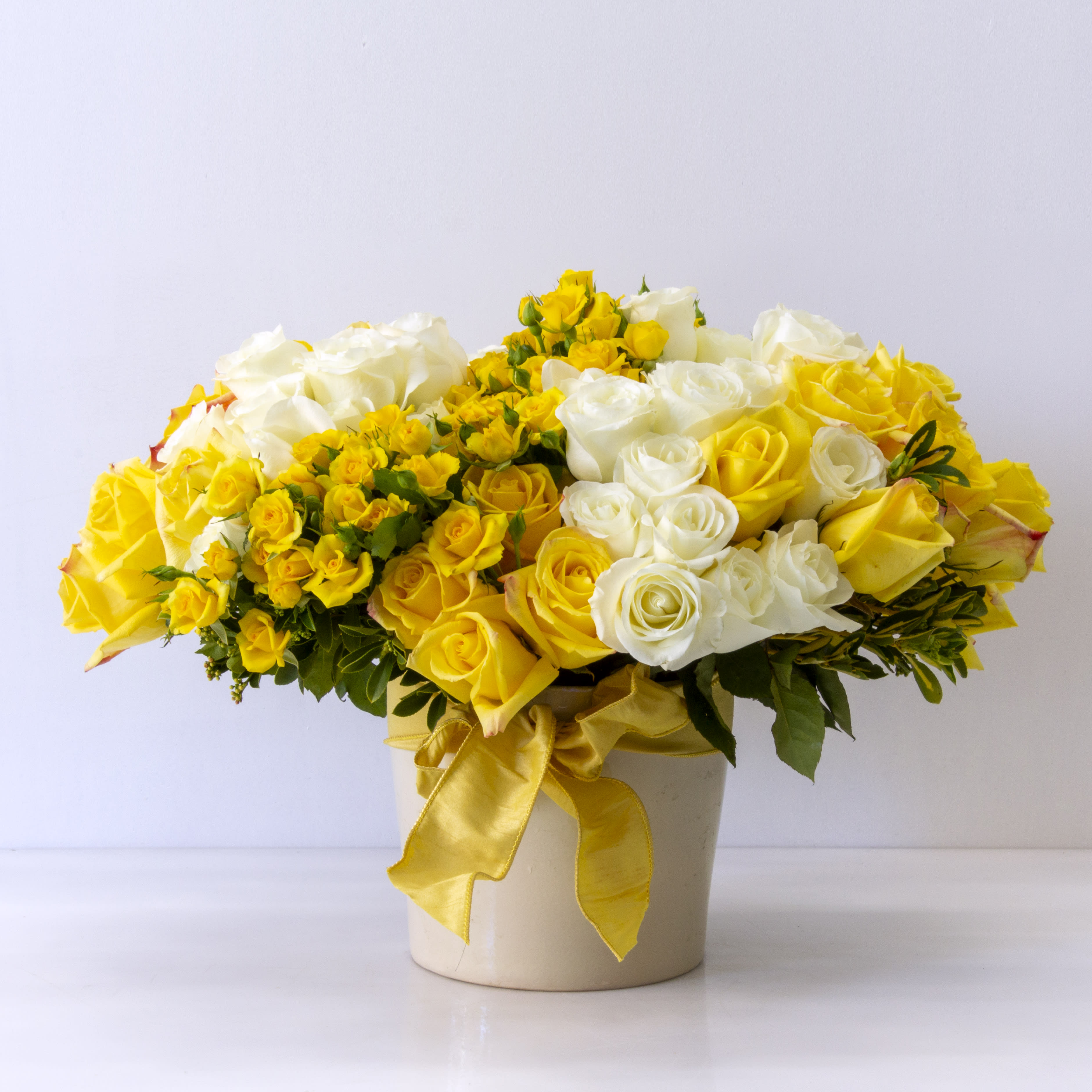Ms. Clueless - Over 75 Ecuadorian Roses and Locally Grown Spray roses in a Ceramic Vase 