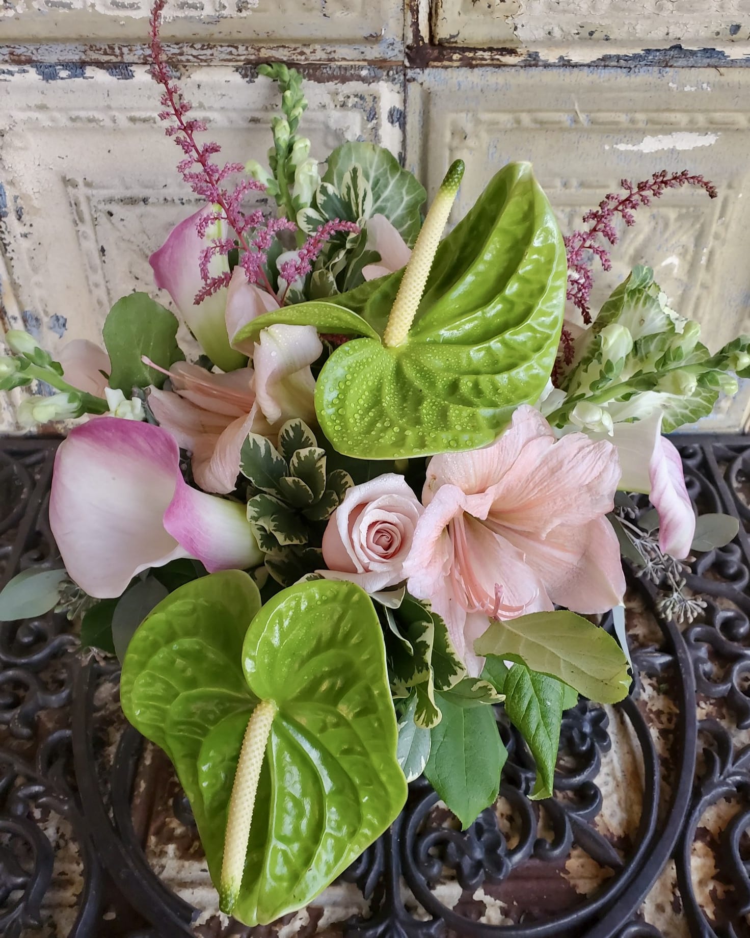 Louisa May Alcott - Feel pretty in pink with this stunning arrangement of anthurium, amaryllis, calla lilies, kale, roses, snapdragons, eucalyptus, astilbe, and greens.