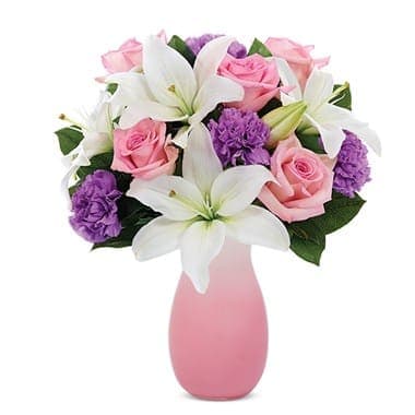 Perfect In Pastel Bouquet Perfect In Pastel Bouquet - Pink roses, white Asiatic lilies and purple carnations are blended imaginatively in a pink ombre vase. The result is an astonishingly beautiful bouquet that underscores the magical allure of pastel colors. Measures 12”H X 9”L.