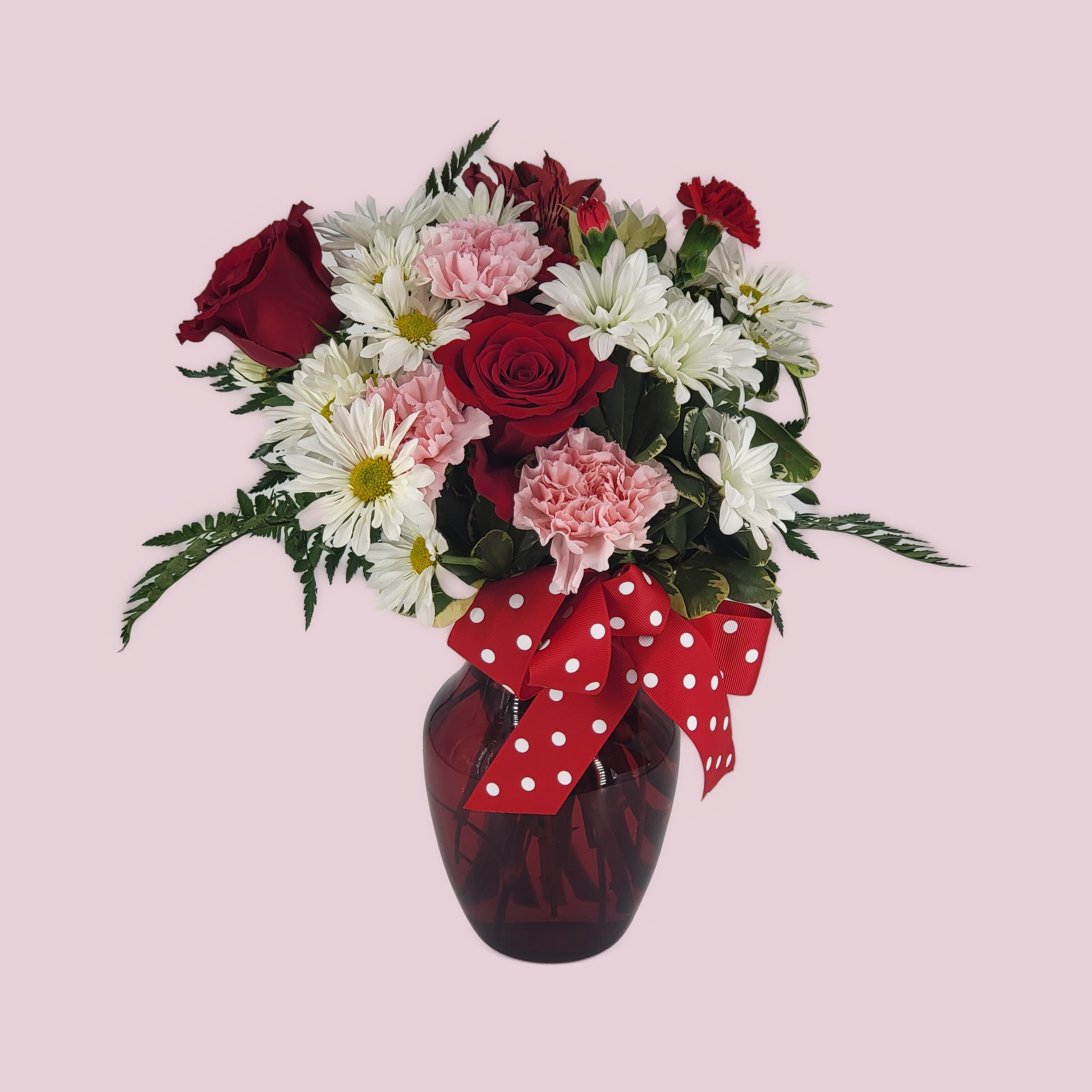 Hugs &amp; Kisses - The charming bouquet includes white daisy spray chrysanthemums, pink carnations, red miniature carnations and red roses accented with fresh greenery in a stylish red vase. Approximately 12 1/2&quot; W x 15&quot; H