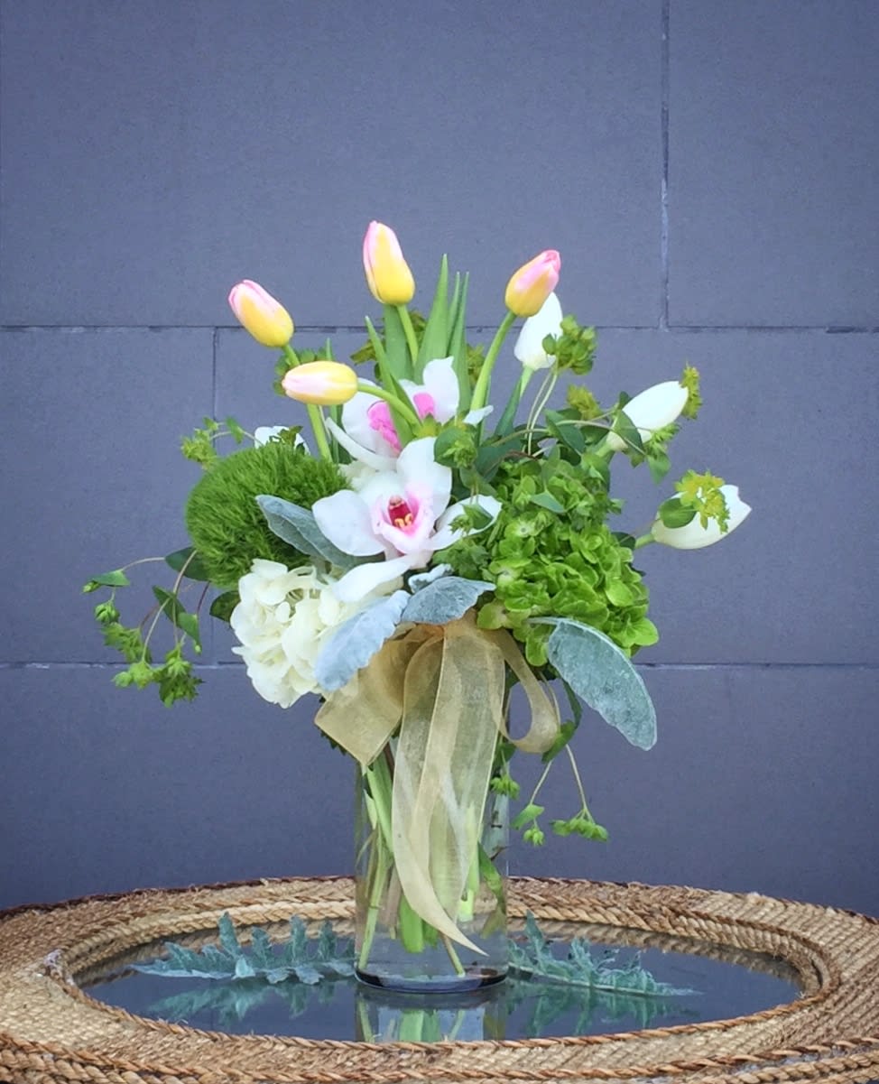 Smiling Tulips - Lovely design including tulip, orchid, hydrangea and accents in a glass vase.