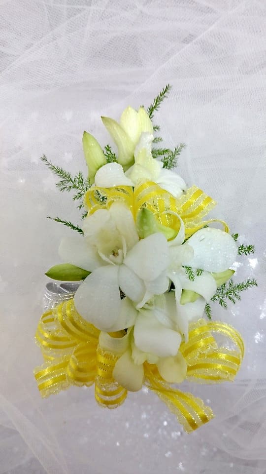 Yellow Corsage Yellow Corsage - Corsage that includes white orchids, yellow ribbon, and plumosa.
