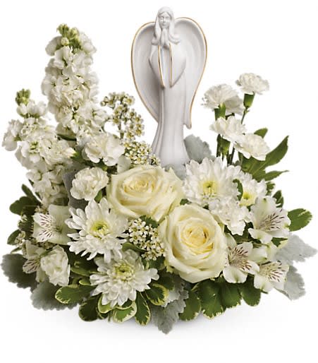 Guiding Light Bouquet - Peaceful and majestic, a graceful angel rests amongst fragrant, snow white roses, alstroemeria and stock - a touching tribute to a bright life and your unending support.  White roses, white alstroemeria, white stock, white miniature carnations, white cushion spray chrysanthemums are arranged with white waxflower, dusty miller and variegated pittosporum. Delivered with an Angel of Grace keepsake. Approximately 16 1/2&quot; W x 14&quot; H