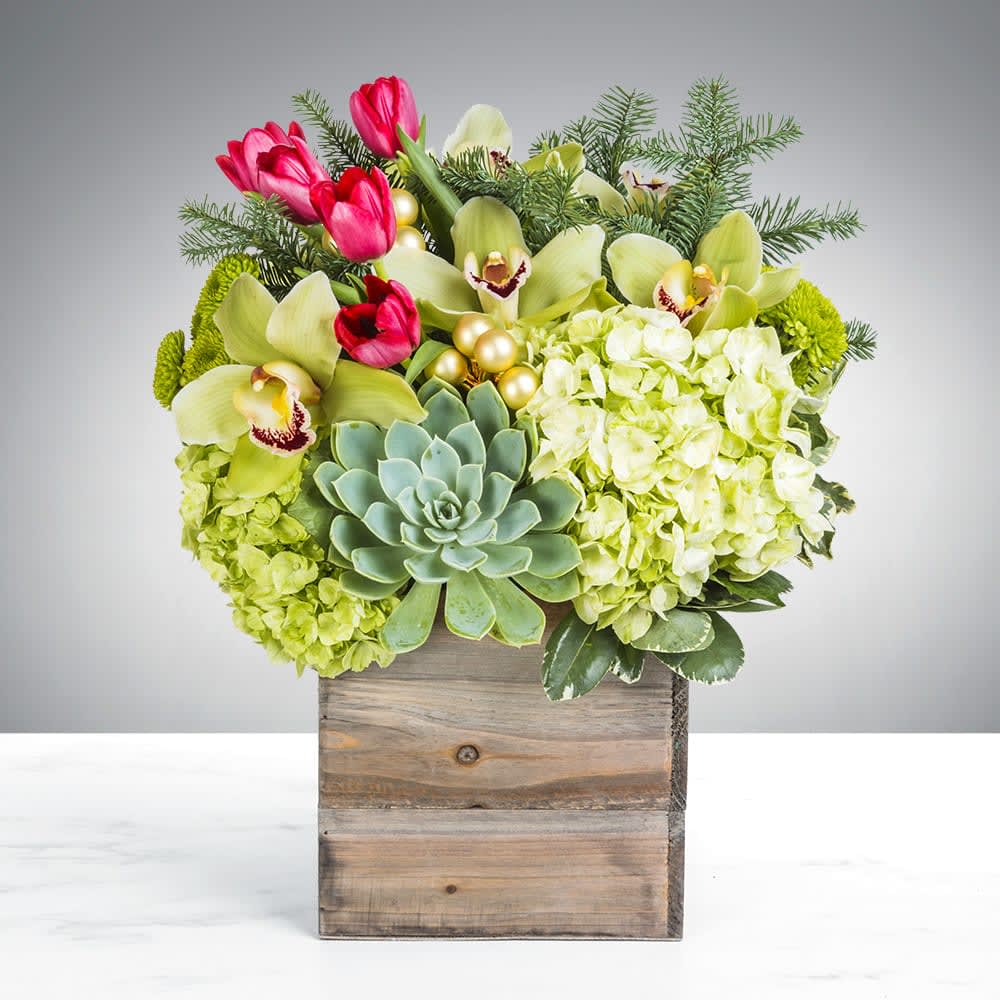 Home for the Holidays By BloomNation™ - You’re going home for the holidays, shouldn’t your flowers get the same courtesy? Introducing Home for the Holidays. Housed in a blissful wooden box, this arrangement is proud to bring its home wherever it goes. Turn your house into a home with this welcoming arrangement.