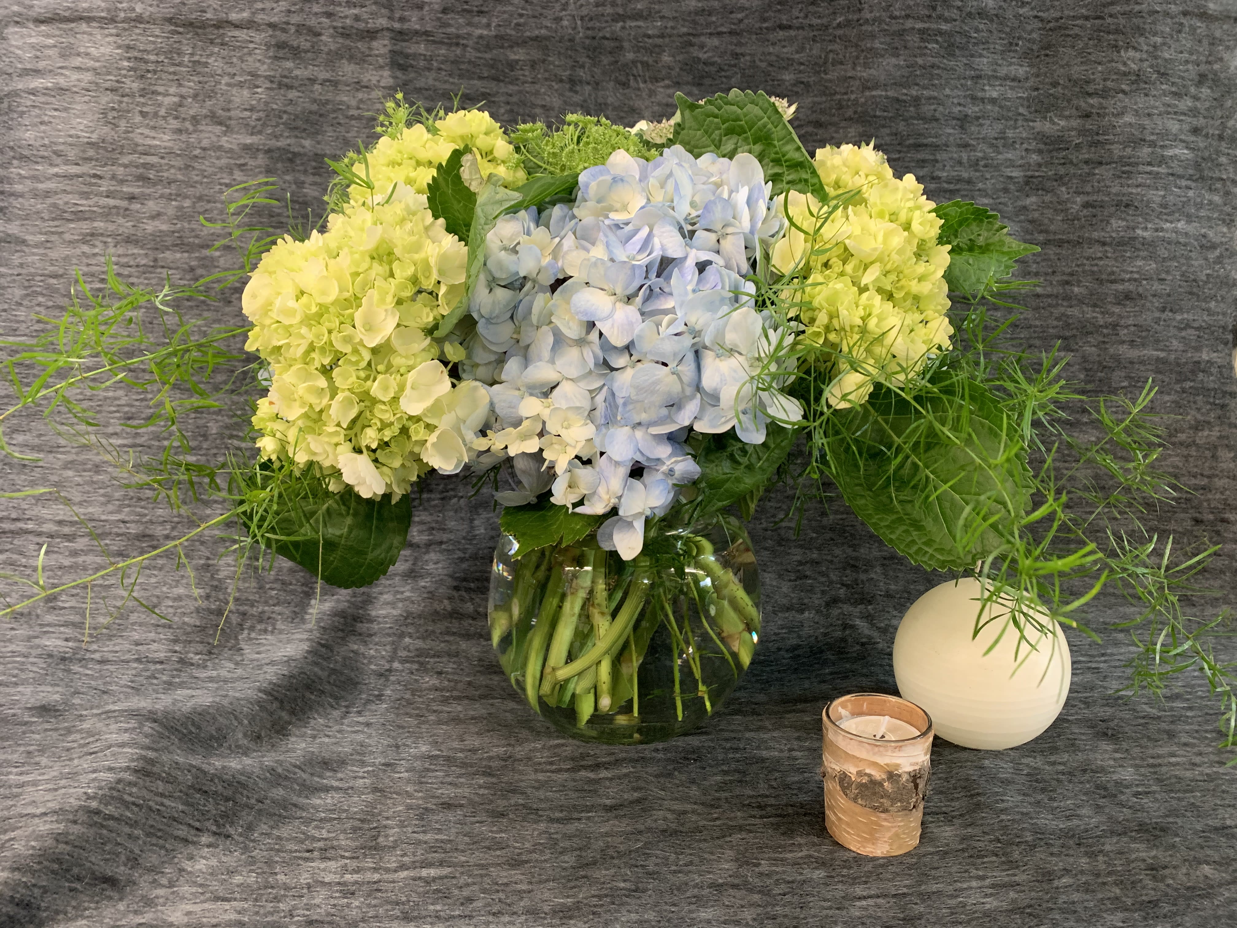 Hydrangea Bowl - Memories of summer, hydrangea are a perennial favorite. This brimming over bowl is abundant with green an blue blooms.