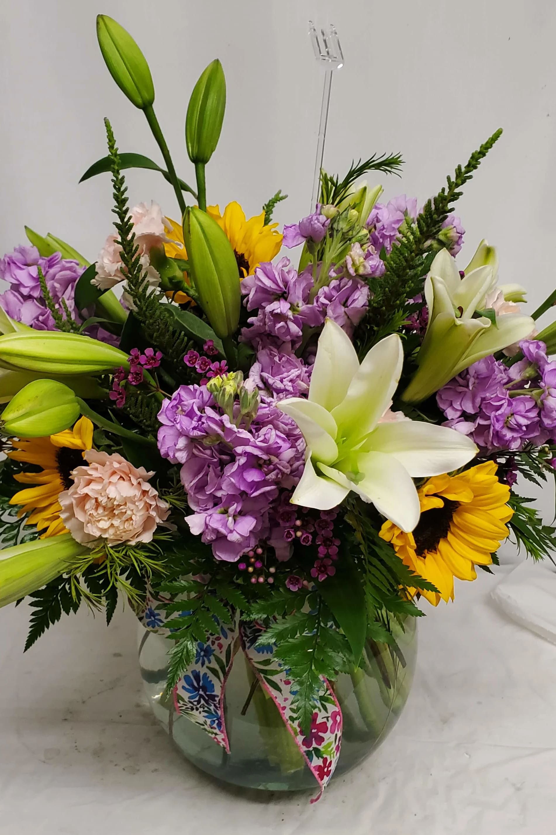Spring fish bowl - Fish bowl vase with white lily, sunflowers, pink carnations and lavender stock   
