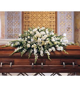 TF1953  - Dlx Pure White Cskt Spry Symbolizing humility and reverence, the white flowers of this elegant spray create a white-on-white blanket of blossoms. Combining textures, sizes and shapes, its graceful style evokes modesty and innocence. One casket spray is delivered decorated with white carnations, gerberas, gladioli, asters, orchids, roses and stock, along with emerald palm and salal. Approximately 69&quot; W x 33&quot; H TF195-3
