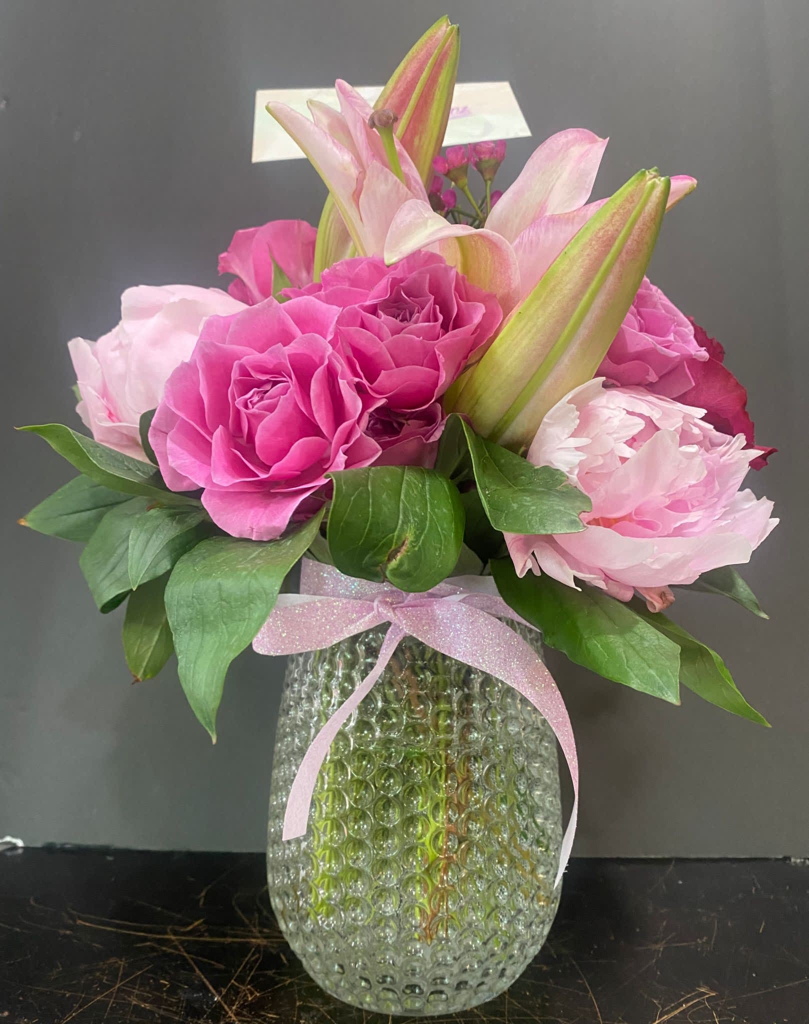 The Joyfulpinks The Joyfulpinks - Pink Peonies, Pink lilies, Pink spray roses and greens in a class container. for all occation